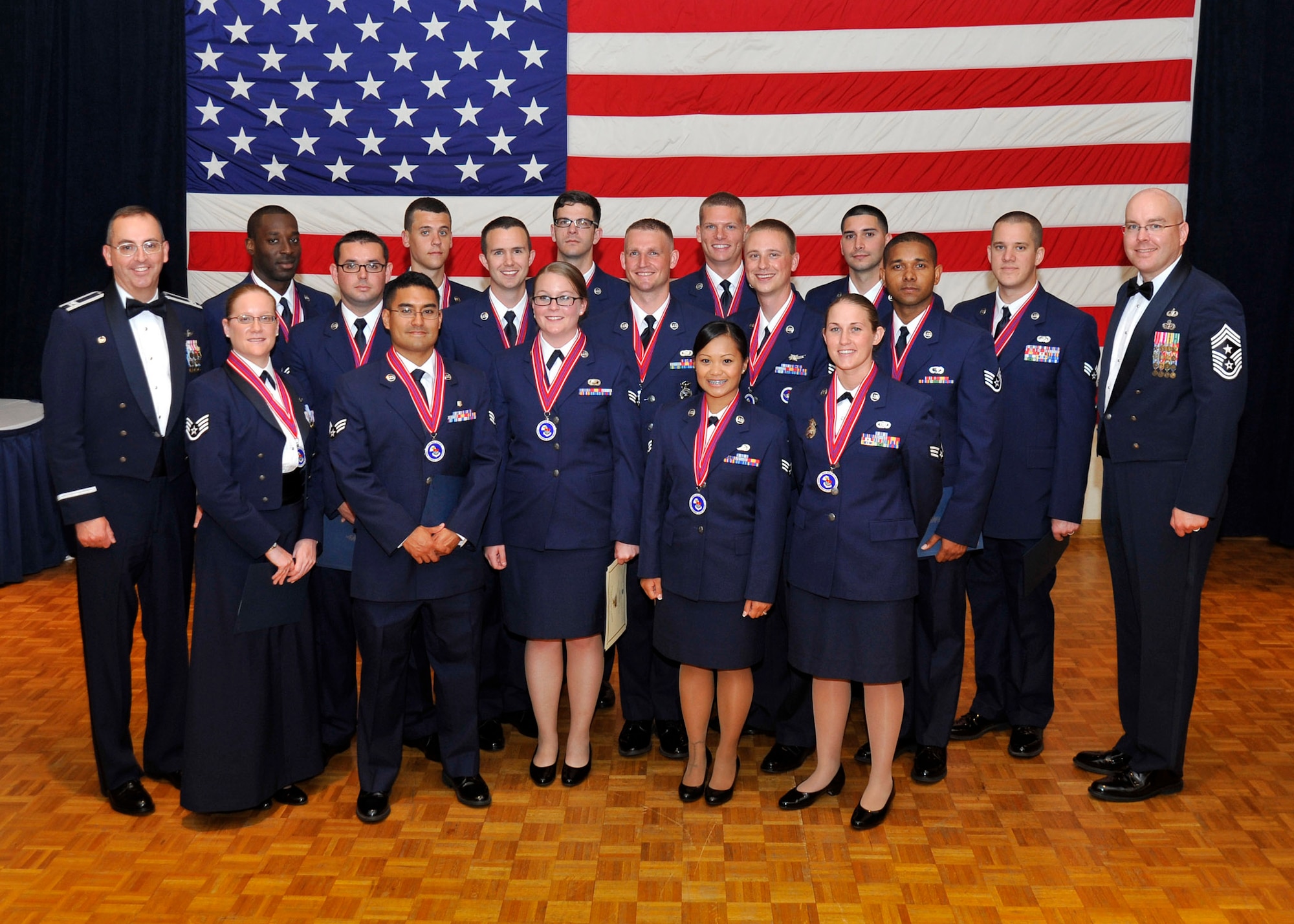 VANDENBERG AIR FORCE BASE, Calif. -- Col. Keith Balts, 30th Space Wing commander, and Chief Master Sgt. Ryan Peterson, 30th Space Wing command chief, join the graduating members of Airman Leadership School Class 13-E for a group photo during a ceremony here Thursday, 20 June. ALS is a five week-long United States Air Force program designed to develop airmen into effective front-line supervisors, focusing on the development of leadership abilities as well as effective communication. (U.S. Air Force photo/Michael Peterson)