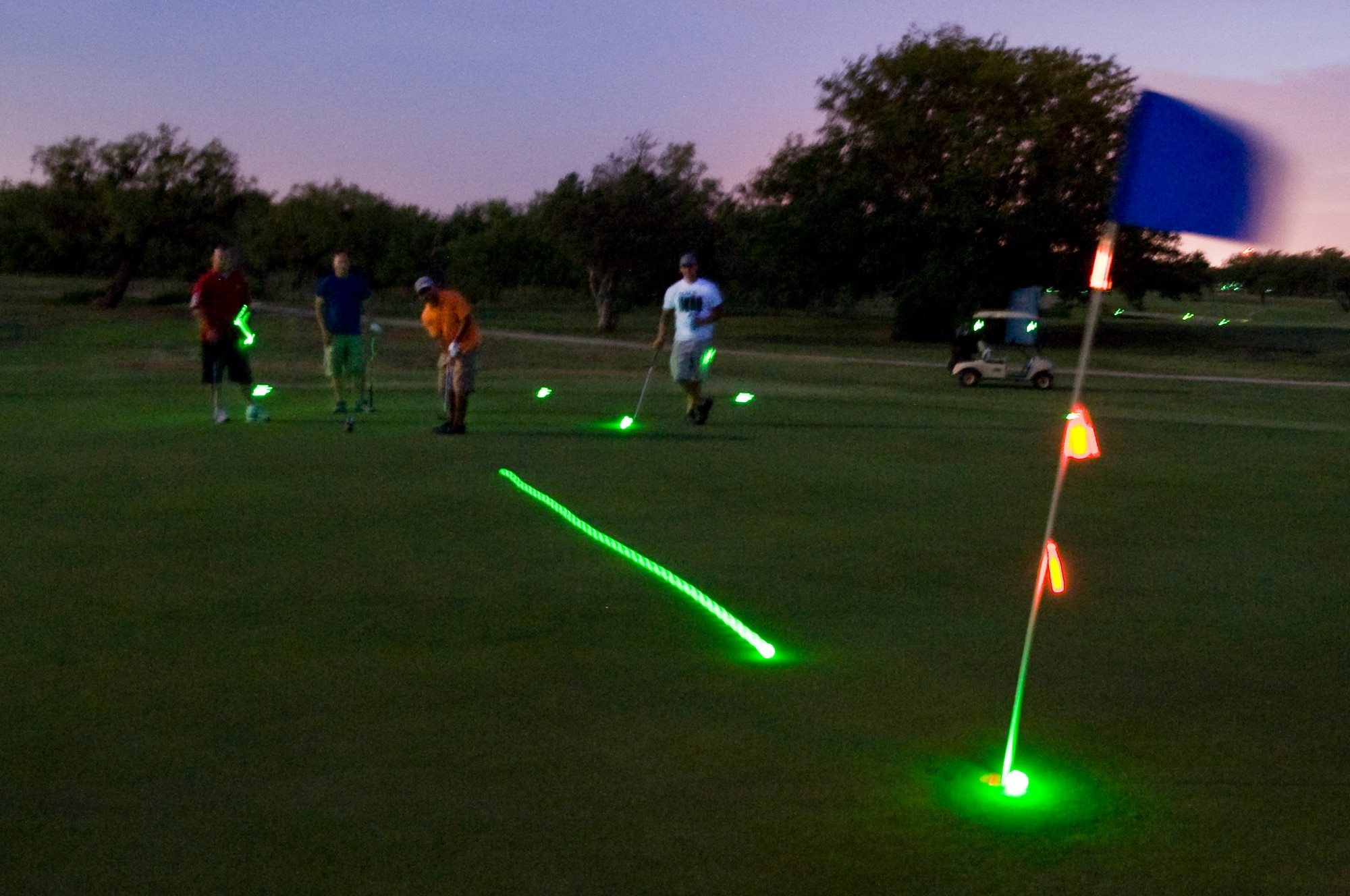 An Airman from the 7th Munitions Squadron putts for a birdie during a night golf tournament June 21, 2013, at Dyess Air Force Base, Texas. Members of Team Dyess converged on the Mesquite Grove Golf Course to show their support for the 7th Security Forces Squadron and Taylor County Sherriff’s Office by participating in a night golf tournament to raise funds for their organizations.  (U.S. Air Force photo by Airman 1st Class Peter Thompson/Released)