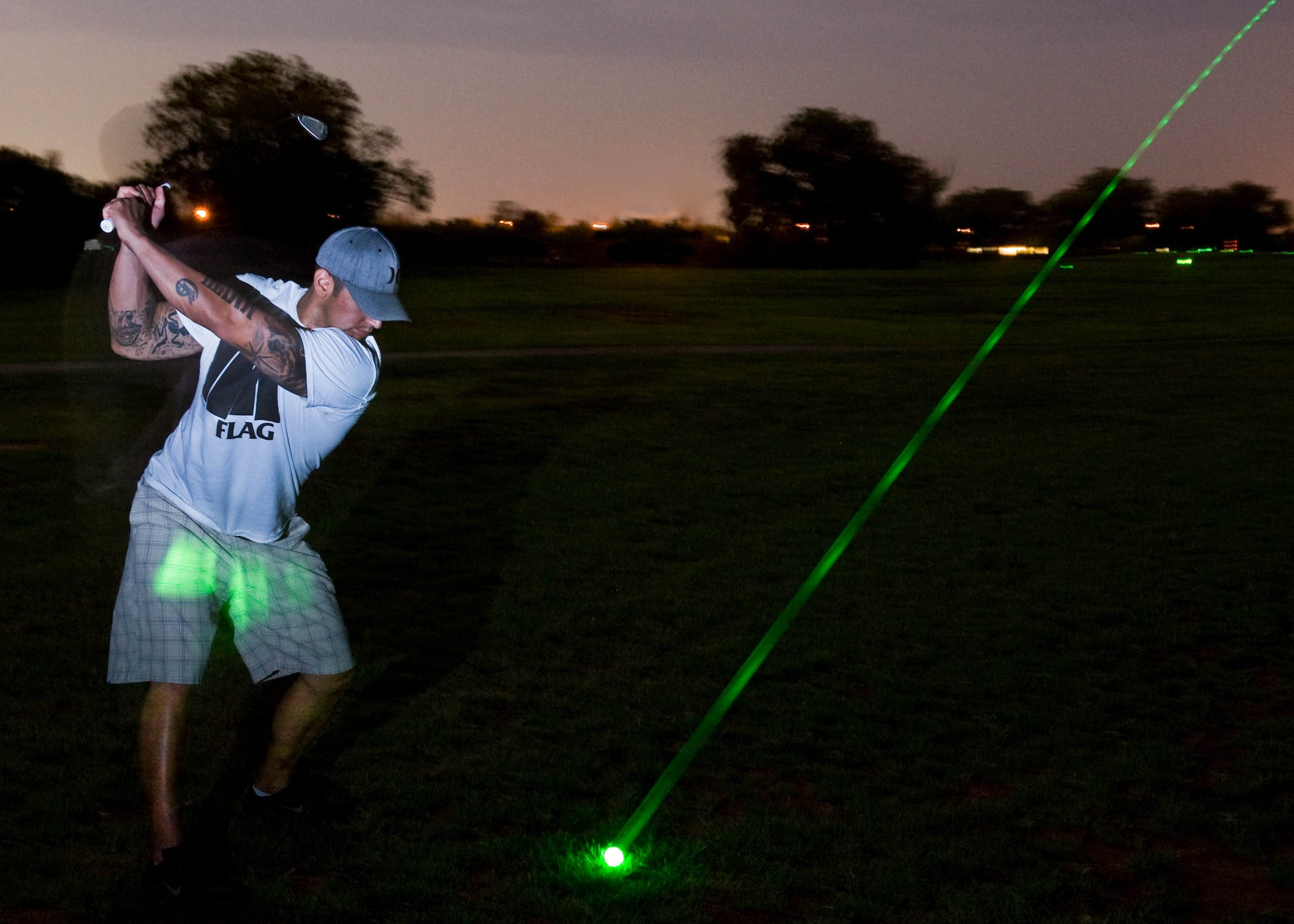 U.S. Air Force Tech. Sgt. Elind Garcia, 7th Munitions Squadrons, hits a glow-in-the-dark golf ball June 21, 2013, at Dyess Air Force Base, Texas. Participants of the night golf tournament played the first nine holes during the daytime with the following nine at night. (U.S. Air Force photo by Airman Autumn Velez/Released)