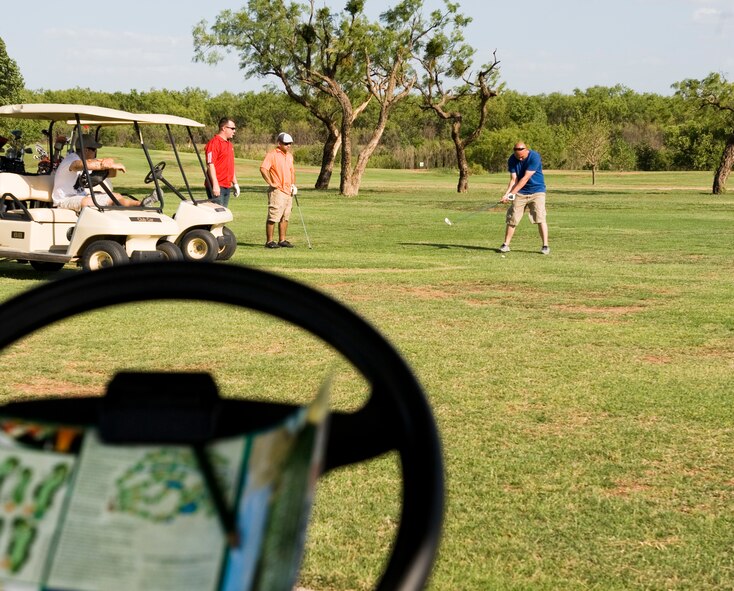 An Airman from the 7th Munitions Squadron chips a golf ball from the fairway June 21, 2013, at Dyess Air Force Base, Texas. Originally scheduled during National Police Week, a week dedicated to paying respect to police officers who have paid the ultimate sacrifice, the 7th Security Forces Squadron hosted the golf tournament to raise funds for the Defender’s Association and the Taylor County Sherriff’s Office. (U.S. Air Force photo by Airman 1st Class Peter Thompson/Released)