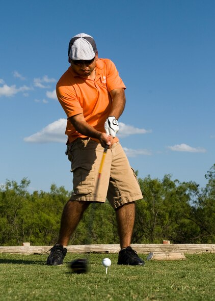 U.S. Air Force Staff Sgt. Juan Hernandez, 7th Munitions Squadron, tees off at the second hole of the night golf tournament June 21, 2013, Dyess Air Force Base, Texas. Hosted by the 7th Security Forces Squadron, the golf tournament raised more than $1,000 for the Defender’s Association and the Taylor County Sherriff’s Office. (U.S. Air Force photo by Airman 1st Class Peter Thompson/Released)