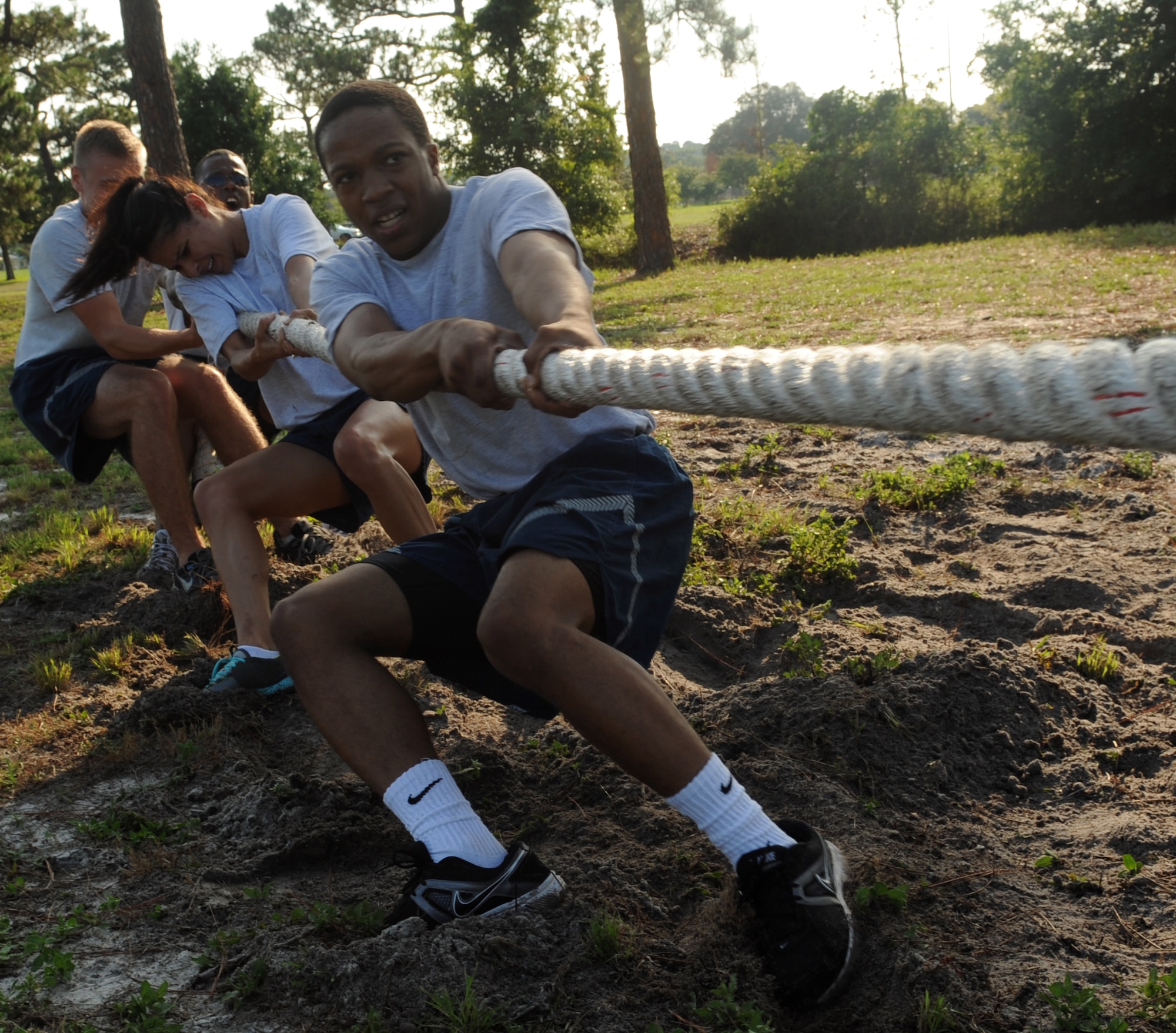 Airmen from 1st Special Operations Comptroller Squadron give tug-of-war their all during the ‘Air Commandos Versus Sexual Assault’ obstacle course, held near Child Development Center Main on Hurlburt Field, Fla., June 21, 2013. Obstacles included flipping a large tractor tire, weaving between cones while dodging water balloons, low and high crawls on sands of the Soundside beach and more. (U.S. Air Force photo by Senior Airman Kentavist P. Brackin)