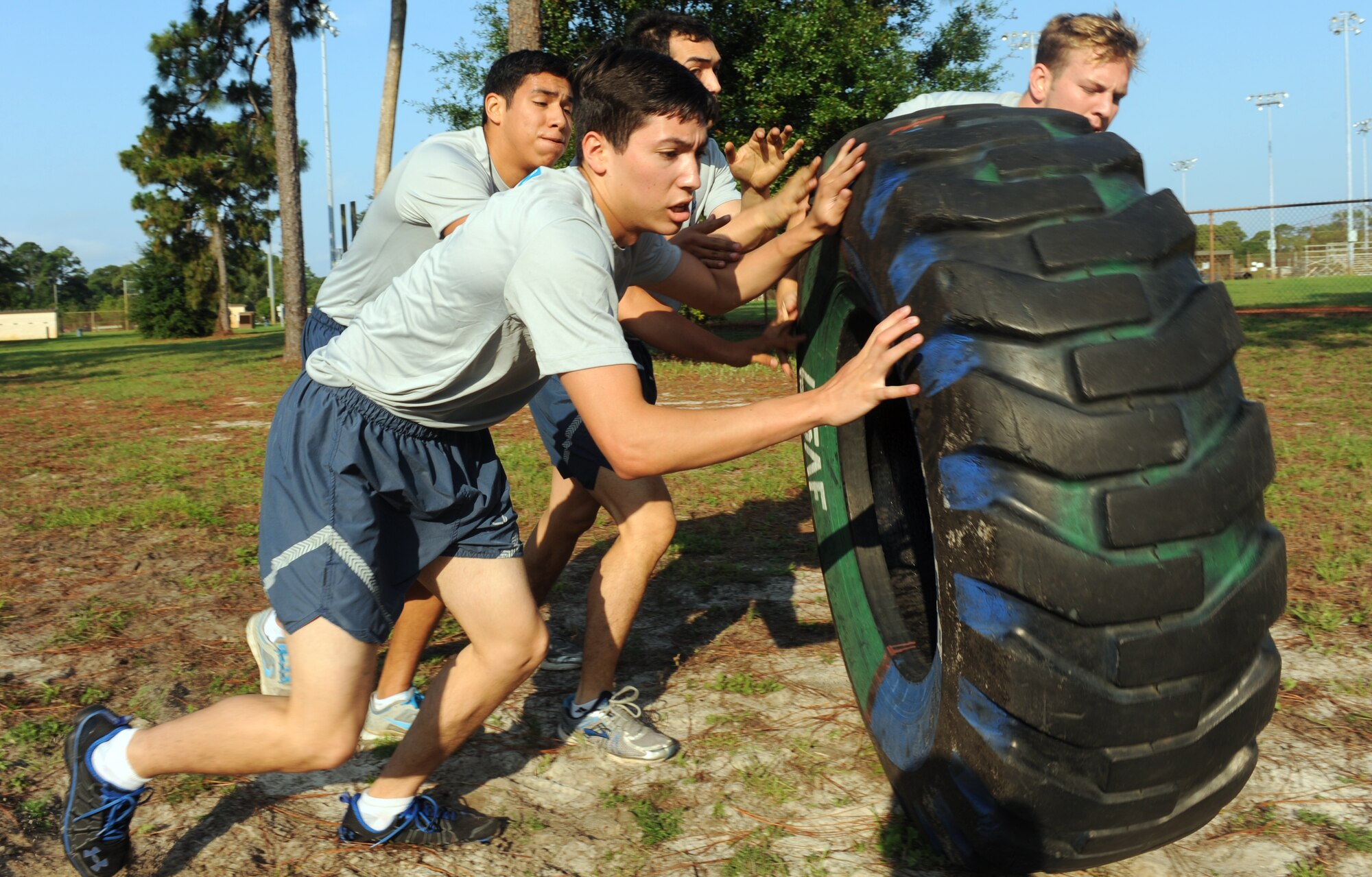 Airmen from the 1st Special Operations Logistics Readiness Squadron flip a tractor tire during the ‘Air Commandos Versus Sexual Assault’ obstacle course, held near Child Development Center Main on Hurlburt Field, Fla., June 21, 2013. The tire flip is one of the many obstacles Airmen faced during the sexual assault awareness event.(U.S. Air Force photo by Senior Airman Kentavist P. Brackin)