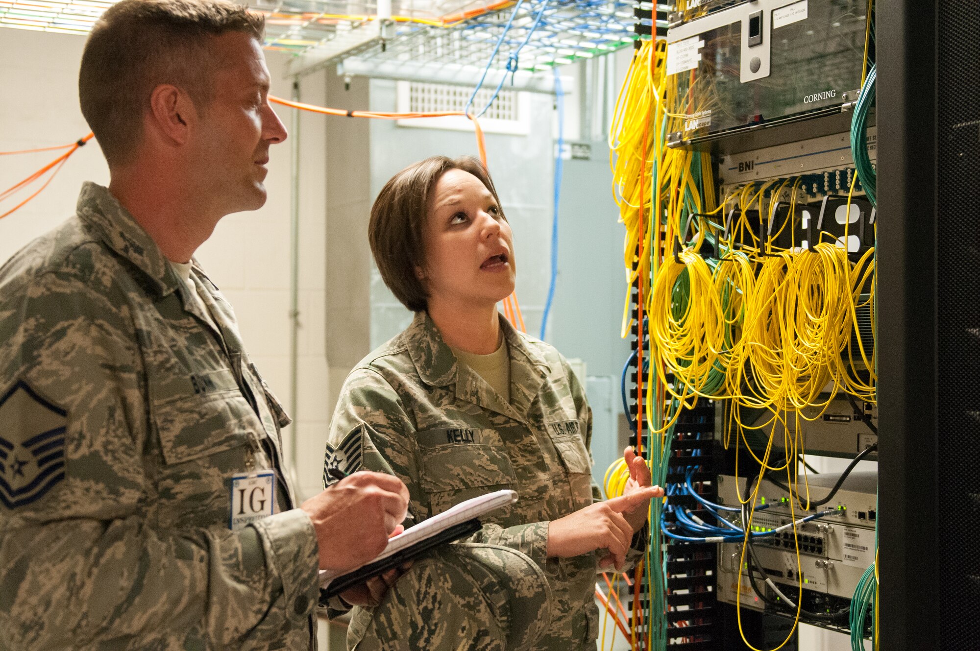Tech. Sgt. Kristin Kelly, cyber transport technician for the Kentucky Air National Guard’s 123rd Communications Flight, examines the 123rd Airlift Wing’s base network infrastructure with Master Sgt. Kyle Bunn, an inspector from Air Mobility Command, as part of a Consolidated Unit Inspection at the Louisville, Ky., wing May 19, 2013. The unit underwent the multi-disciplinary inspection between May 15 and 22. (U.S. Air National Guard photo by Senior Airman Vicky Spesard)