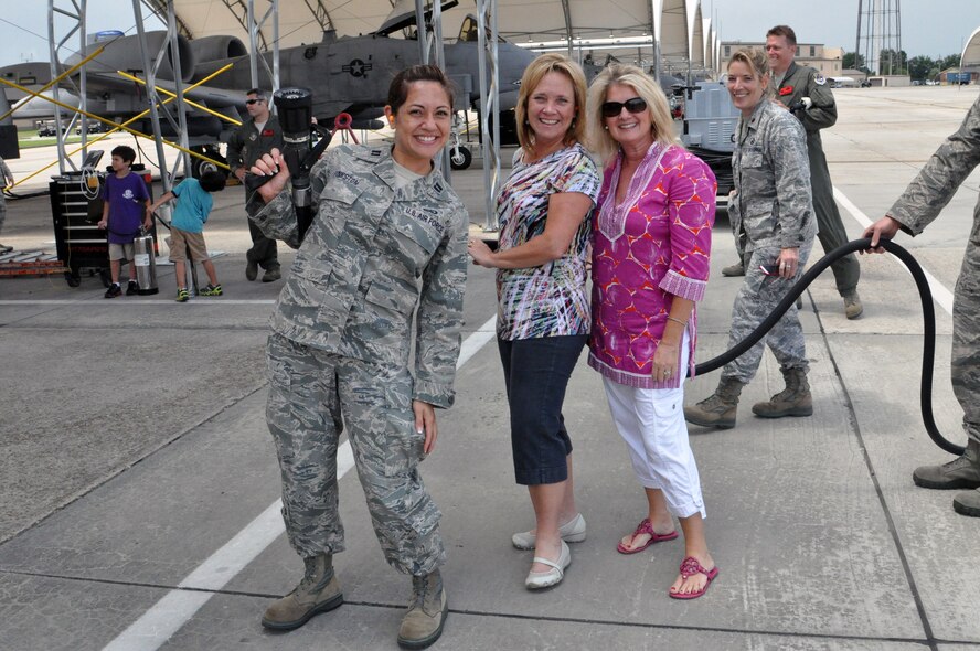 Capt. Erin Pinkston, Susan Sutter and Lori Funk prepare to spray Col. Christian Funk, 476th Fighter Group commander, Moody Air Force Base, Ga., as he returns for his final flight with the group. The 476th FG, Moody AFB, Ga., is a geographically separated unit of the 442nd Fighter Wing, an A-10 Thunderbolt II Air Force Reserve unit at Whiteman Air Force Base, and a classic associate of the 23rd Wing, Moody AFB. (U.S. Air Force photo by Tech. Sgt. Danielle Johnston/Released)