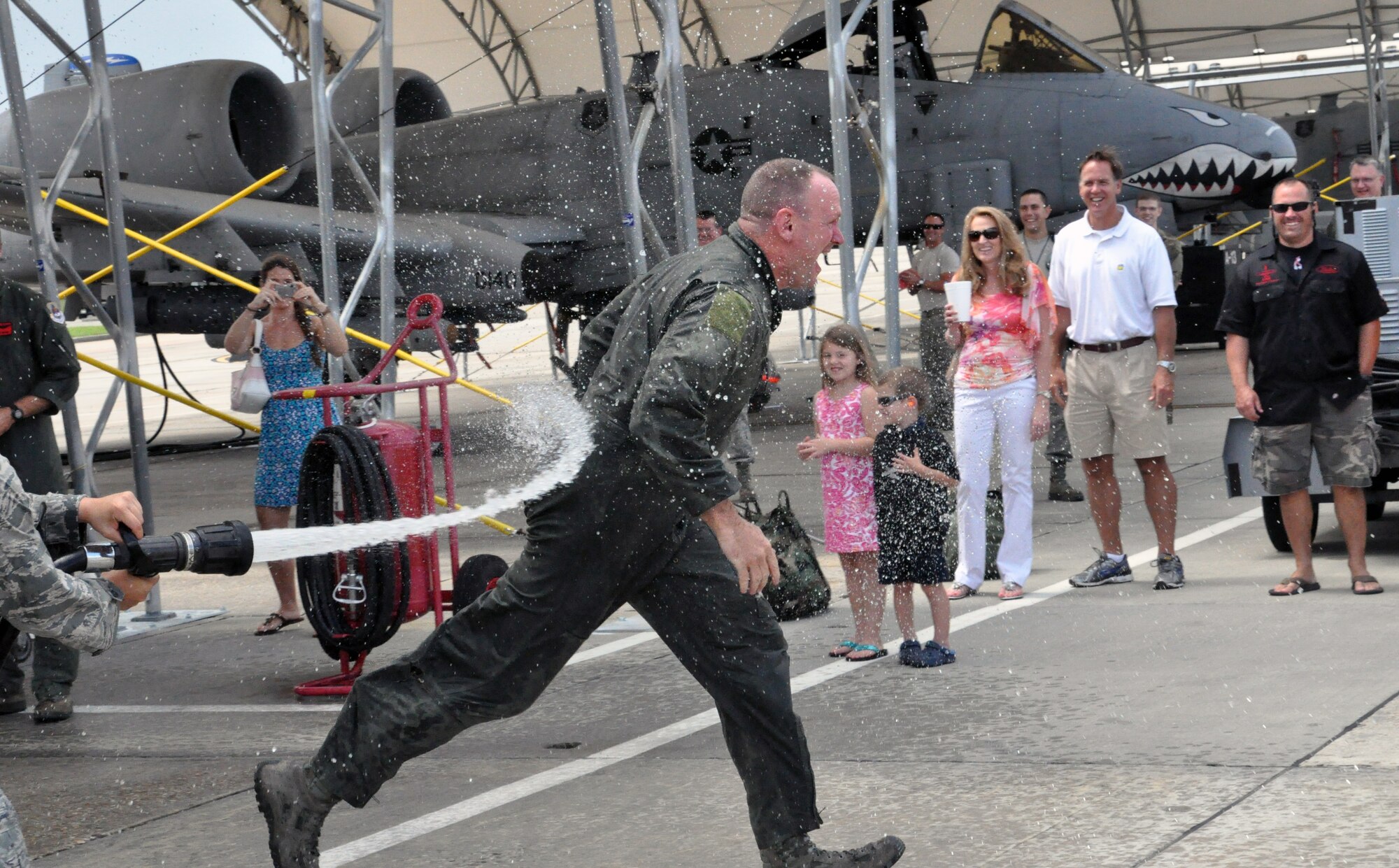 Col. Christian Funk, 476th Fighter Group commander, Moody Air Force Base, Ga., returns for his final flight with the group and is sprayed with a fire hose in line with Air Force tradition. The 476th FG is a geographically separated unit of the 442nd Fighter Wing, an A-10 Thunderbolt II Air Force Reserve unit at Whiteman Air Force Base, and a classic associate of the 23rd Wing, Moody AFB. (U.S. Air Force photo by Tech. Sgt. Danielle Johnston/Released)