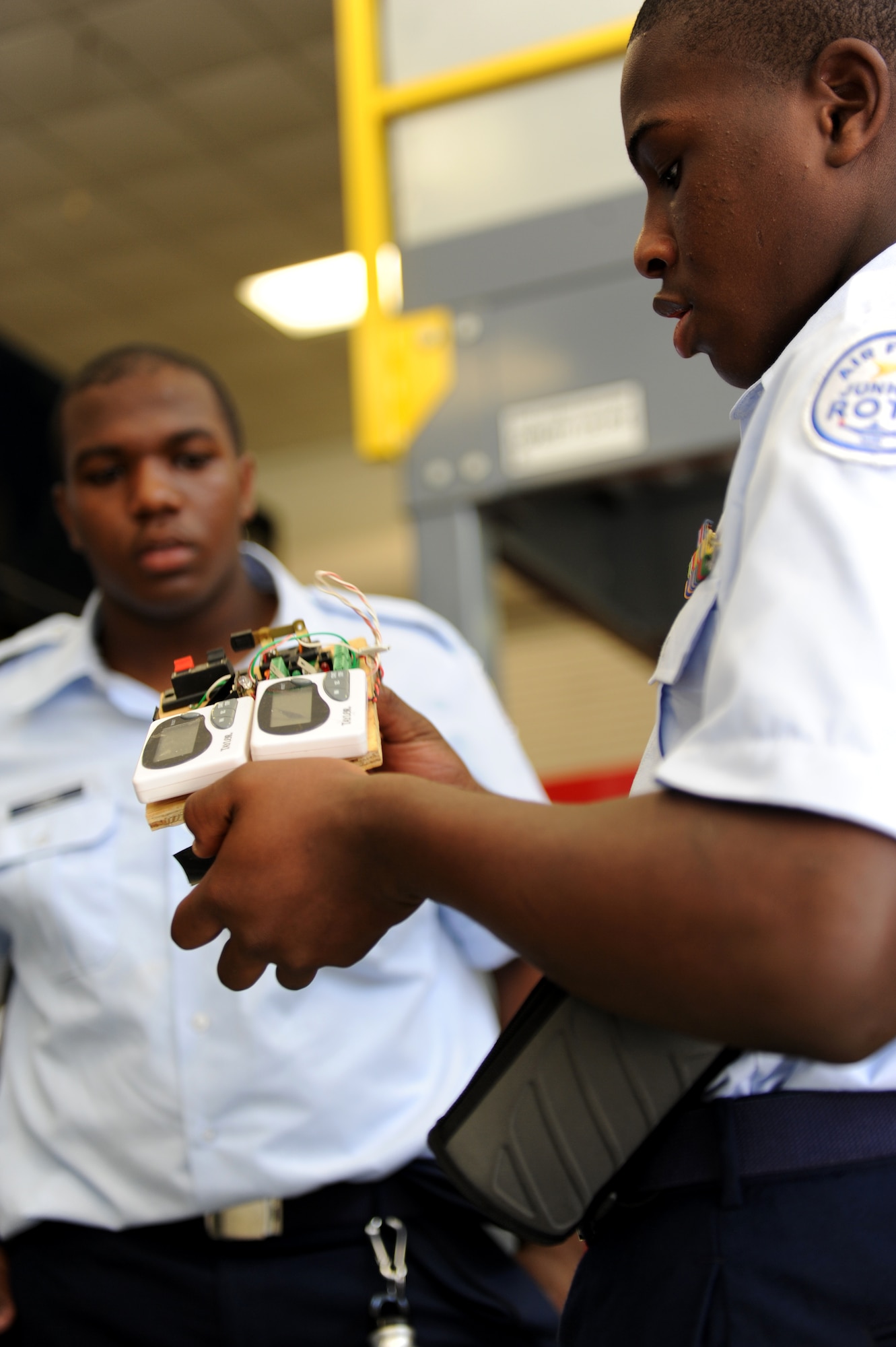 Travis Jones, (left) and Jamelle Ransey, both examine a training device used by the 633rd Civil Engineer Squadron explosive ordinance disposal technicians at Langley Air Force Base, Va., June 25, 2013. The cadets were part of a shadow day with their Junior Reserve Officer Training Corps class. (U.S. Air Force photo by Airman 1st Class Kimberly Nagle/Released) 