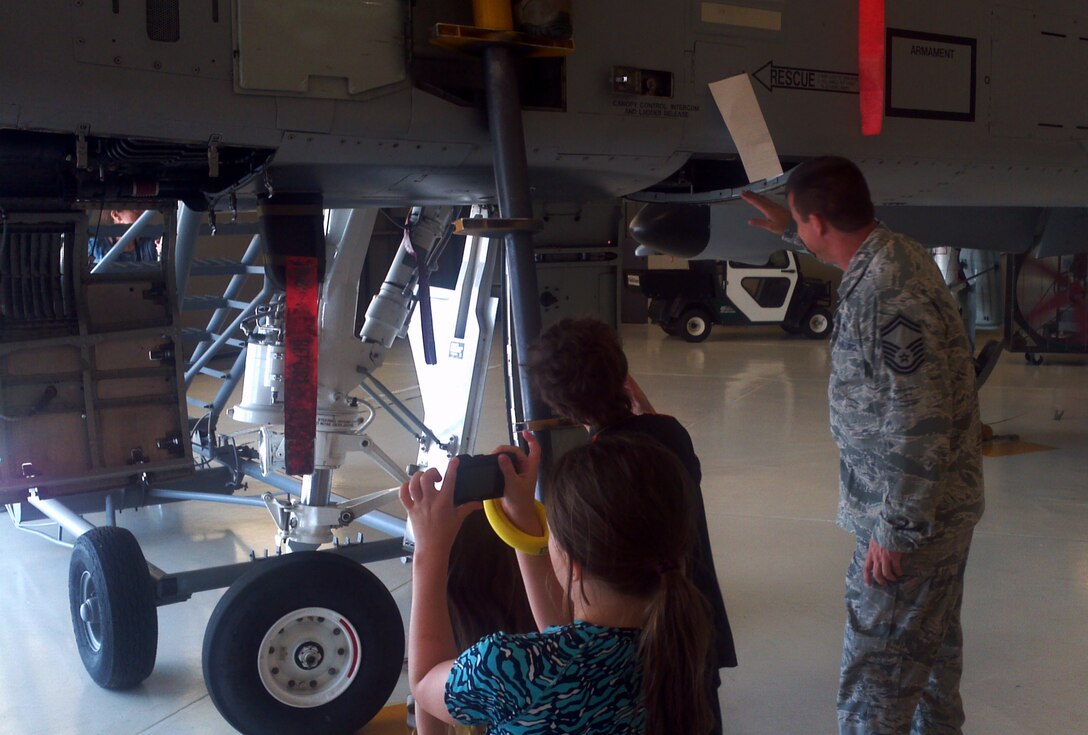 Senior Master Sgt. Dee Tankersley of the 188th Maintenance Group speaks to a throng of students and parents from the Faith Home School Group. The group toured the 188th Fighter Wing June 18. They got the chance to learn about the A-10C Thunderbolt II “Warthogs” and received a capabilities demonstration from the 188th Fire Emergency Services Flight (U.S. Air National Guard photo by Maj. Heath Allen/188th Fighter Wing)