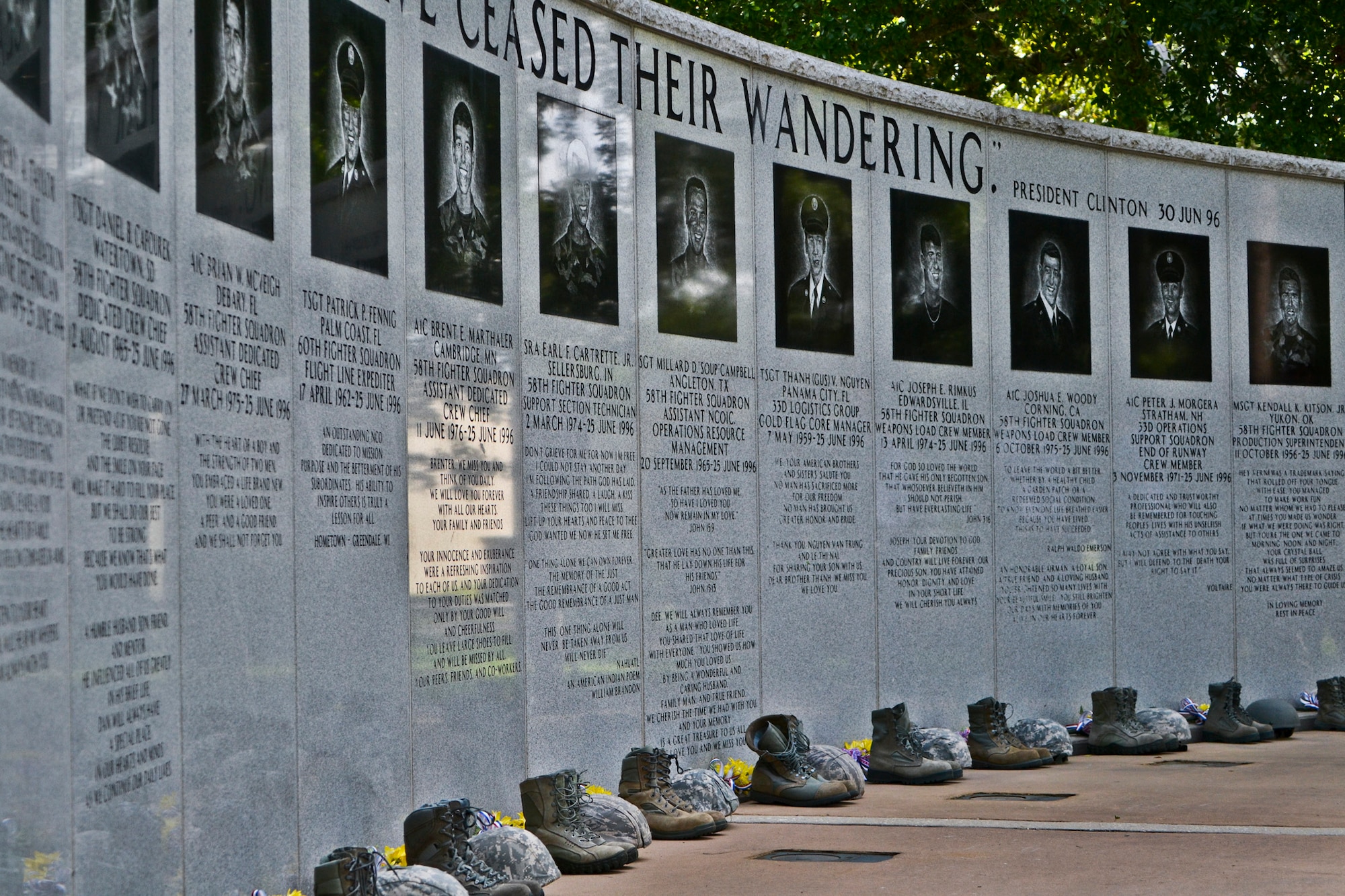 Flowers, helmets and boots were placed along the Khobar Towers Memorial Wall to honor the fallen on the 17th anniversary of the tragic bombing that killed 19 military members, including 12 33rd Fighter Wing Nomads.  (U.S. Air Force photo/Staff Sgt. Nick Egebrecht)
