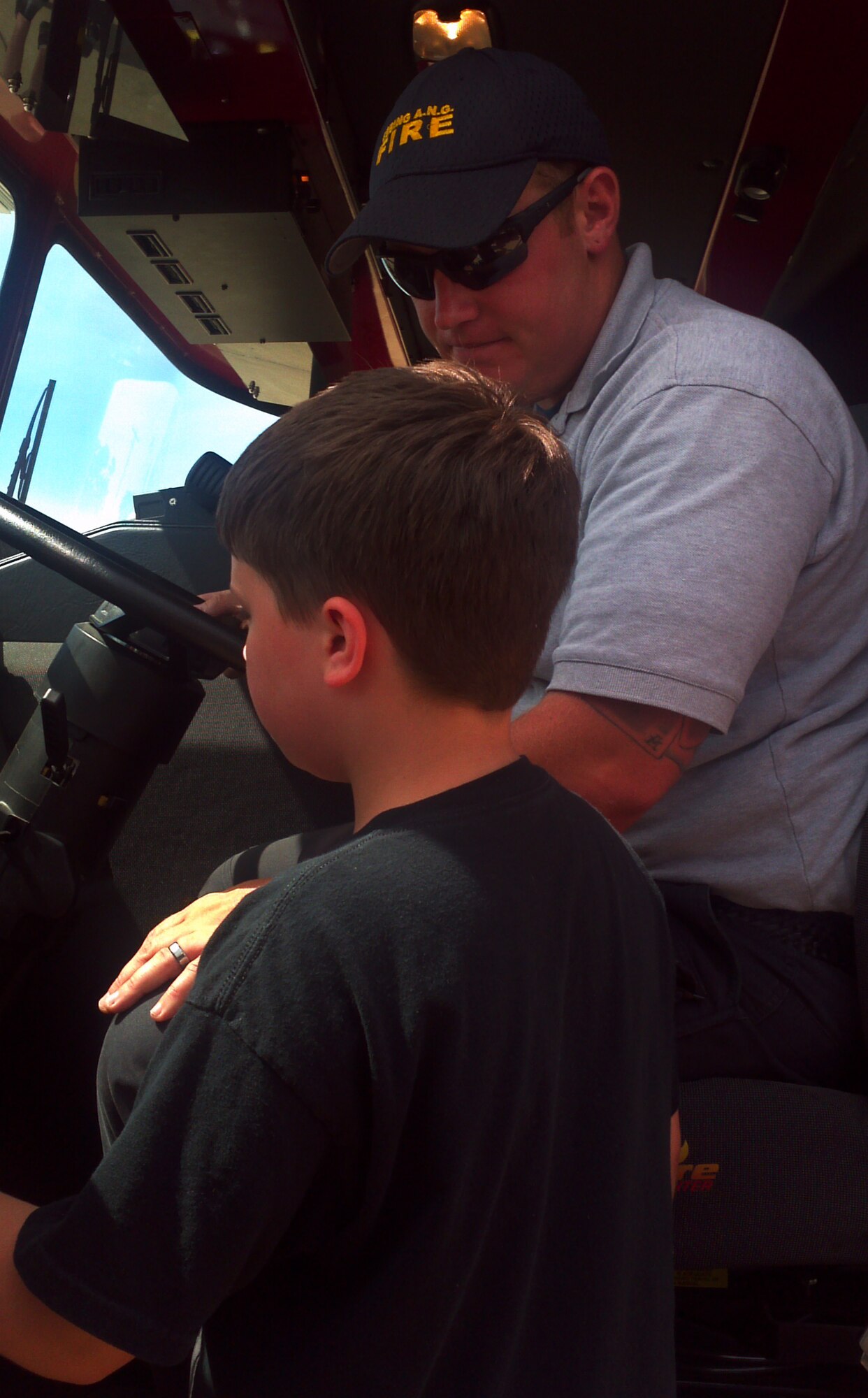 Staff Sgt. Greg Williams, a firefighter with the 188th Fire Emergency Services Flight, speaks to a student from the Faith Home School Group. The group toured the 188th Fighter Wing June 18. They got the chance to learn about the A-10C Thunderbolt II “Warthogs” and received a capabilities demonstration from the 188th Fire Emergency Services Flight (U.S. Air National Guard photo by Maj. Heath Allen/188th Fighter Wing)