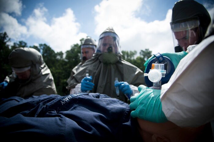 Sailors from the Navy Health Clinic Charleston simulate preparing a patient for the  decontamination tent during the First Receivers Operations Training course June 21, 2013, at Joint Base Charleston - Weapons Station, S.C. The NHCC team participated in the FROT course to educate their Sailors on life saving skills consisting of triage, initiate field treatment, decontaminate and save victims from Chemical, Biological, Radiological/Nuclear, or Hazardous Material. The 16-hour course consisted of one, eight-hour day of class lecture and a second eight-hour day of "hands-on" teamwork training to include a final "timed" exercise. (U.S. Air Force photo/Staff Sgt. Rasheen Douglas)