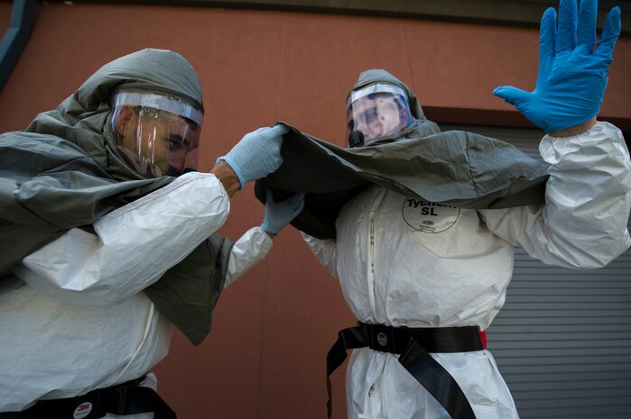 Sailors from the Navy Health Clinic Charleston check each other to make sure their personal protective equipment is being worn properly during their final "timed" exercise during the second day of the First Receivers Operation Training course June 21, 2013, at Joint Base Charleston - Weapons Station, S.C.  The 16-hour course consisted of one, eight-hour day of class lecture and a second eight-hour day of "hands-on" teamwork training to include a final "timed" exercise. NHCC team’s mission capable time was three minutes and forty-six seconds. Their set up completion time was seven minutes and fifteen seconds. They exceeded U.S. Navy standard times despite being their first time training with the equipment. (U.S. Air Force photo/Staff Sgt. Rasheen Douglas)