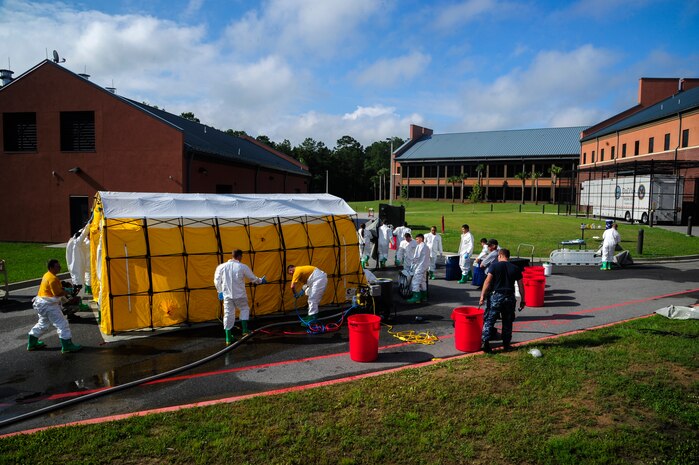 Sailors from the Naval Health Clinic Charleston practice assembling a decontamination tent before executing their final timed exercise June 21, 2013, at Joint Base Charleston - Weapons Station, S.C. The NHCC team participated in a First Receivers Operation Training course designed to educate U.S. Navy Medical First Receivers on life-saving skills required to triage, initiate field treatment, decontaminate and save victims from Chemical, Biological, Radiological/Nuclear, or Hazardous Material. The 16-hour course consisted of one, eight-hour day of class lecture and a second eight-hour day of "hands-on" teamwork training to include a final "timed" exercise. (U.S. Air Force photo/Staff Sgt. Rasheen Douglas)