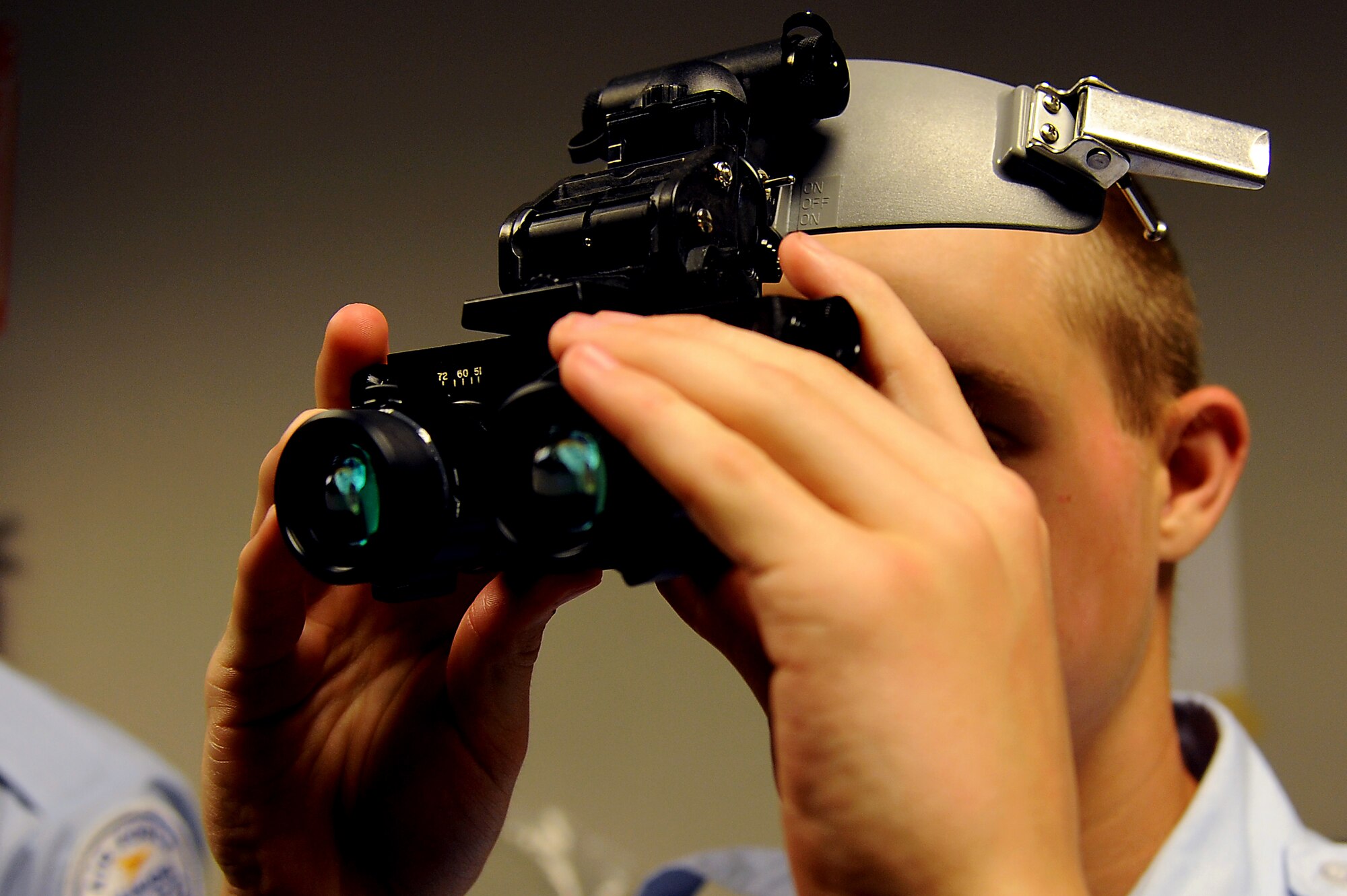 Andrew Hansinger, U.S. Air Force Junior Reserve Officers’ Training Corps cadet, tests out a pair of night-vision goggles during the AFJROTC shadow day at Langley Air Force Base, Va., June 25, 2013. AFJROTC cadets were shown various parts of the base to learn about the operational Air Force. (U.S. Air Force photo by Airman 1st Class Victoria H. Taylor/Released) 