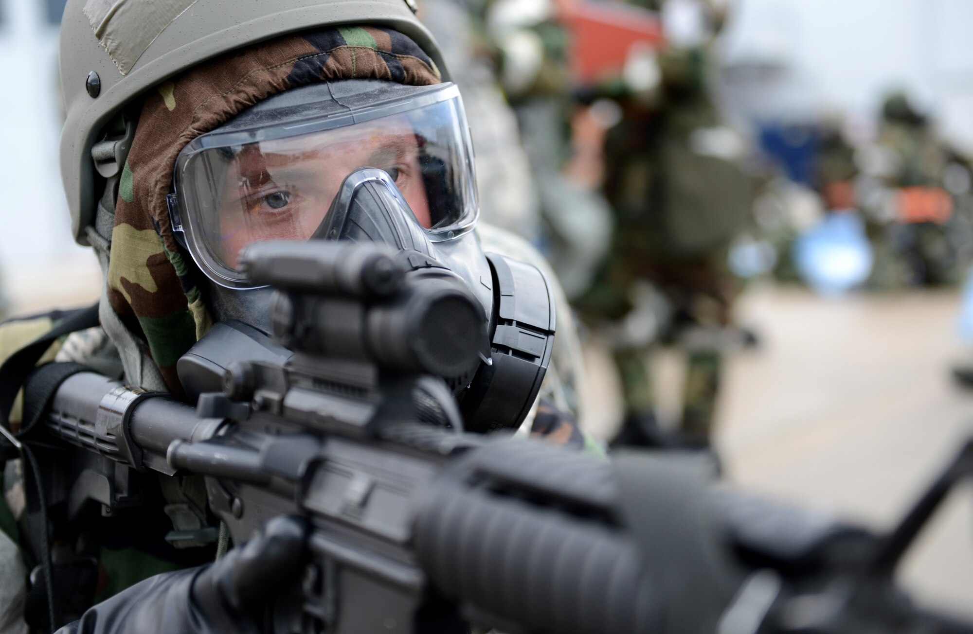 U.S Air Force Airman Sean Pozehl, a member of the Nebraska Air National Guard???s 155th Security Forces Squadron, stands guard in a full chemical suit outside a simulated bunker during an Ability to Survive and Operate exercise at the Nebraska National Guard air base in Lincoln, Neb., June 11, 2013. Members of the 155th ARW participated in the ATSO to evaluate and improve their capabilities and skills in a wartime scenario. (U.S. Air National Guard photo by Staff Sgt. James Lieth/Released)