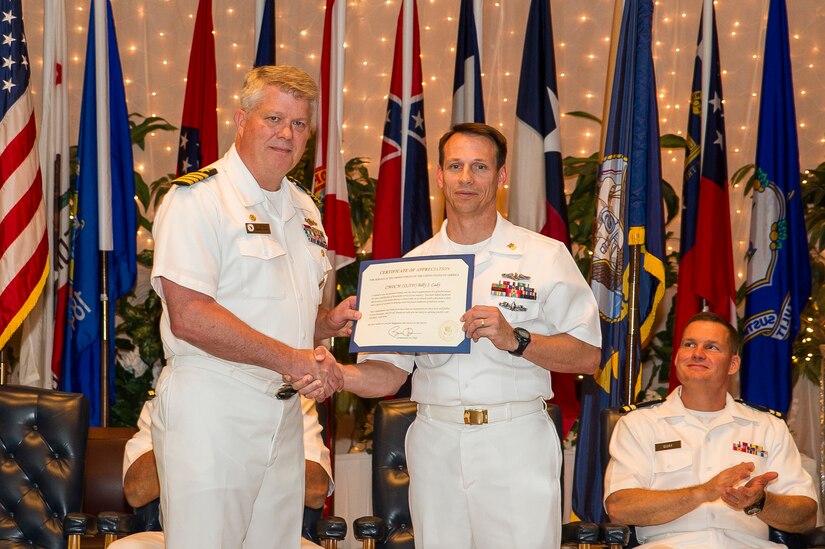 Navy Capt. Tom Bailey, Joint Base Charleston deputy commander, presents a retirement certificate to Master Chief Billy Cady, Naval Support Activity Charleston command master chief June 21, 2013, at the Red Bank Club at Joint Base Charleston – Weapons Station, S.C. Cady served more than 30 years in the U.S. Navy and is a native of Charleston, S.C., where he enlisted as a seaman in September of 1983. (U.S. Air Force photo/ Senior Airman George Goslin)