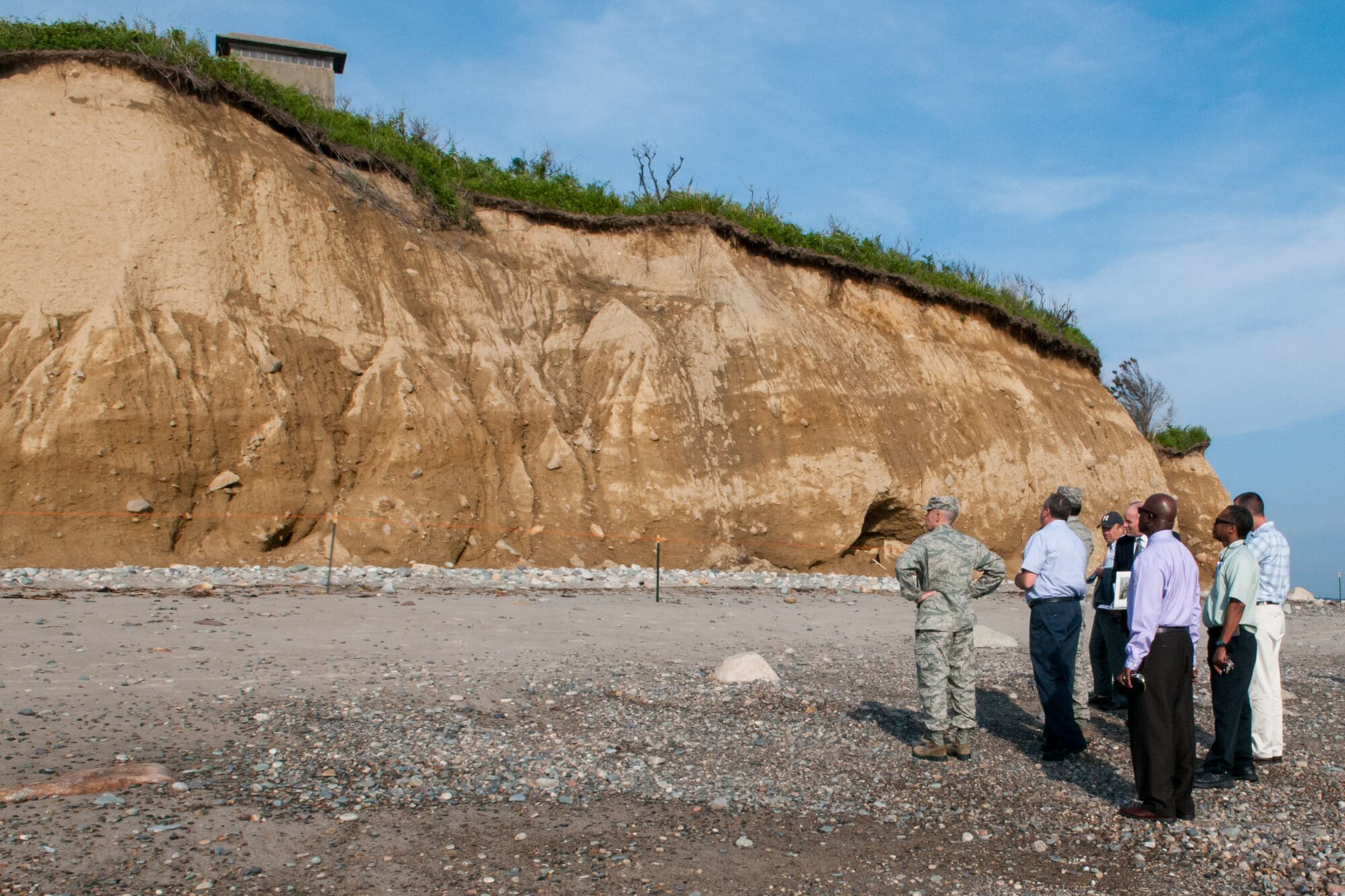SCITUATE, Mass. -- Air Force Life Cycle Commander Lt. Gen. C.D. Moore II, Col. Lester A. Weilacher, 66th Air Base Group commander, and others examine the effects of erosion at the Fourth Cliff Family Recreation Area here June 26. Moore received a tour of the area primarily to observe the extent of the erosion, which has caused some safety concerns and could threaten historical and recreational assets on the property. (U.S. Air Force photo by Rick Berry)