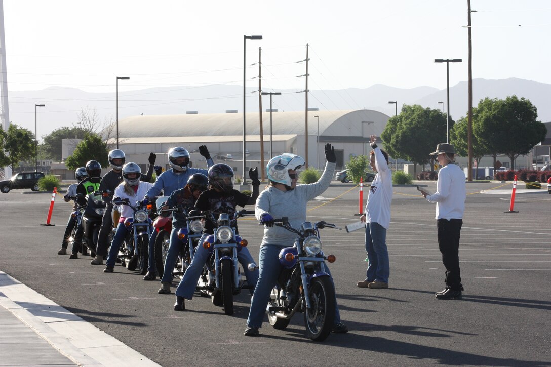 Catherine Porcher and Aaron Hock, Kirtland motorcycle RiderCoaches, prepare students for a training exercise on the range June 7.   
Courtesy photo
