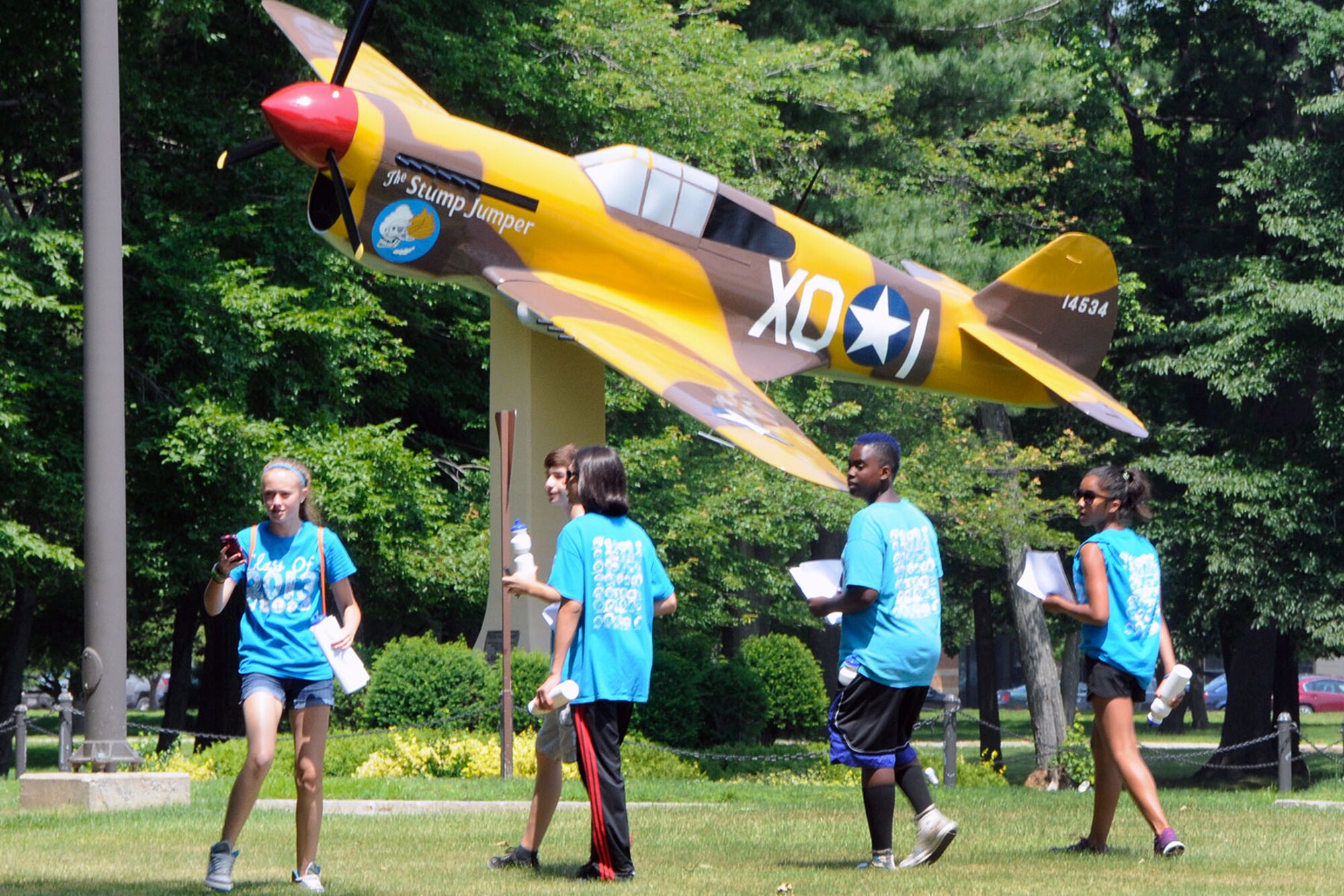 HANSCOM AIR FORCE BASE, Mass. -- Graduating eighth grade students from Hanscom Middle School participate in a scavenger hunt June 24 near the P-40 static display. Students worked in teams to locate places on base and were tasked with taking a photo of those places with their cell phone cameras. Teams that had the most locations photographed won. (U.S. Air Force photo by Linda LaBonte Britt)