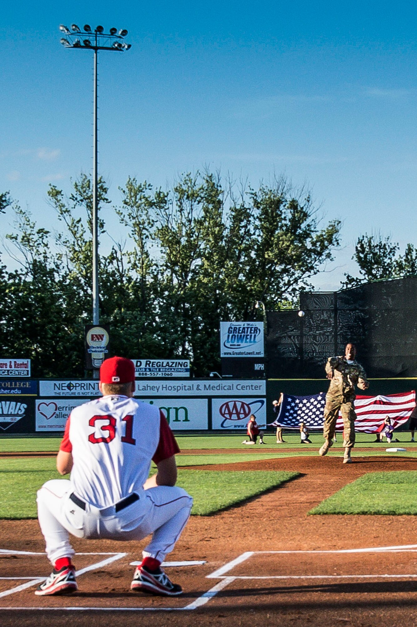 LOWELL, Mass. – Staff Sgt. Johnathan McEachin throws out the first pitch prior to the Lowell Spinners minor league baseball game at LaLacheur Park here June 20. McEachin participated in the event as part of the Hanscom Federal Credit Union’s program, “Heroes Among Us.” McEachin recently returned from a deployment with the Army to an area of operations in Southwest Asia where he was awarded the Bronze Star for meritorious service. (U.S. Air Force photo by Walter Santos)