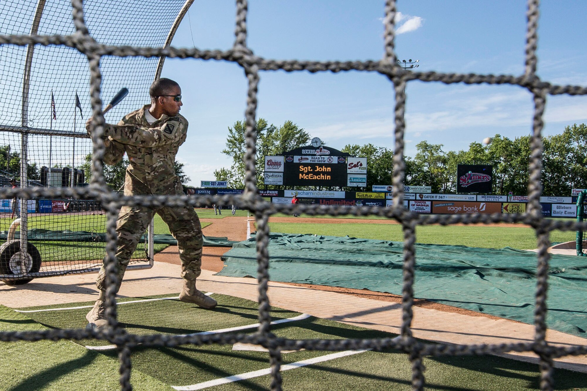 LOWELL, Mass. – Staff Sgt. Johnathan McEachin takes batting practice prior to the Lowell Spinners minor league baseball game at LaLacheur Park June 20. McEachin participated in the event as part of the Hanscom Federal Credit Union’s program, “Heroes Among Us.” McEachin recently returned from a deployment with the Army to an area of operations in Southwest Asia where he was awarded the Bronze Star for meritorious service. (U.S. Air Force photo by Walter Santos)