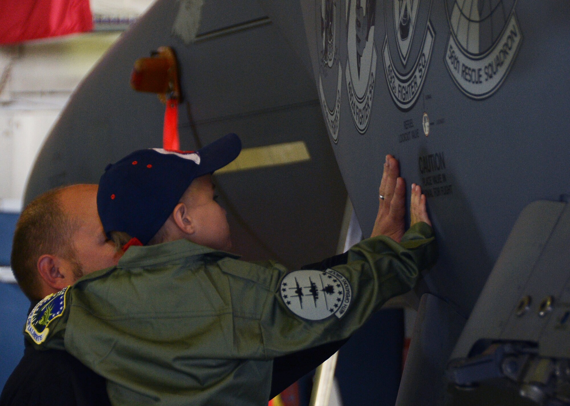 ROYAL AIR FORCE LAKENHEATH, England – Max Rowlandson, 5, from Saffron Walden, receives an up-close view of an F-15E Strike Eagle with his father, Daniel, while participating in the Pilot for a Day program June 25, 2013. The visit, which was specially arranged for Max and another boy battling life-threatening illnesses, included tours of the aircraft control tower and fire department, and aircrew showcased night-vision and other capabilities. (U.S. Air Force photo by Airman 1st Class Trevor T. McBride)