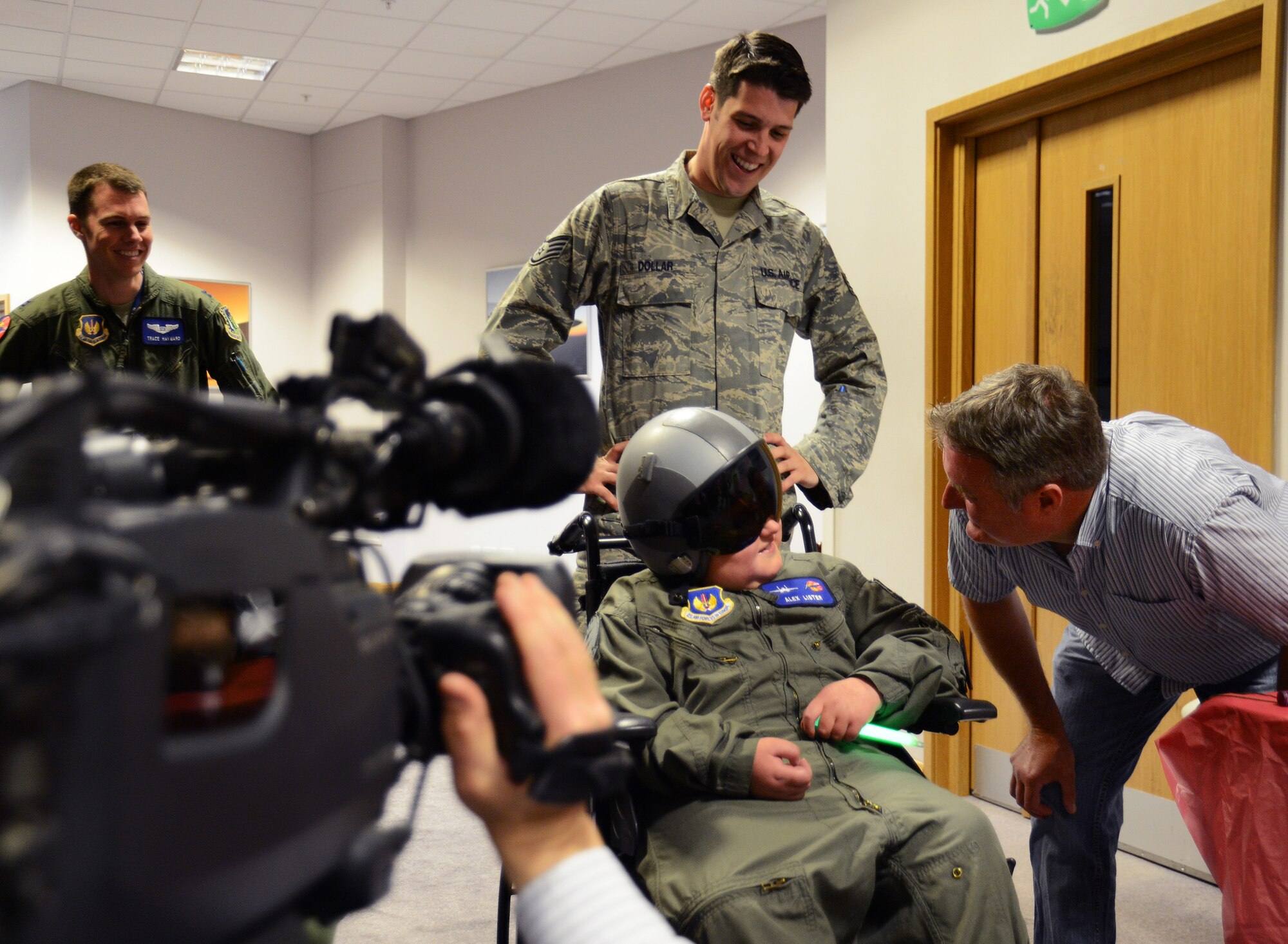 ROYAL AIR FORCE LAKENHEATH, England – Alex Lister, 10, from Licken Village, tries on an F-15 fighter pilot helmet while participating in the Pilot for a Day program June 25, 2013. The visit, which was specially arranged for Alex and another boy battling life-threatening illnesses, included tours of aircraft, the control tower and the fire department, and aircrew showcased night-vision and other capabilities. (U.S. Air Force photo by Staff Sgt. Thomas Trower) 