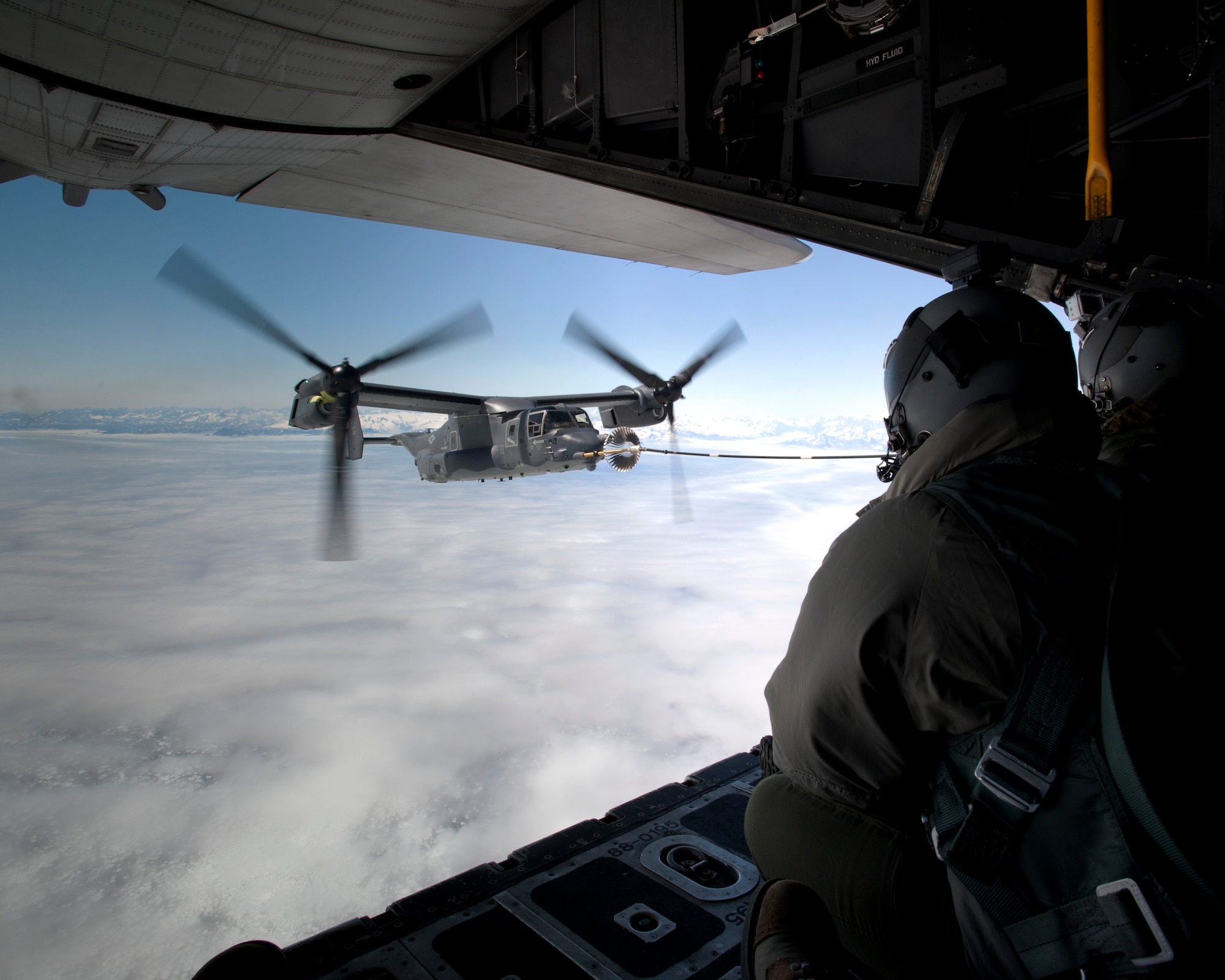 A CV-22B Osprey receives fuel June 21, 2013, off the coast of Greenland by a 7th Special Operations Squadron MC-130H Combat Talon II. The aircraft landed in Iceland during its journey to RAF Mildenhall, England, to allow for crew rest and refueling. The CV-22, assigned to the 7th SOS, is the first of 10 slated to arrive as part of the 352nd Special Operations Group expansion, which will last through the end of 2014. (U.S. Air Force photo by Senior Airman Laura Yahemiak/Released)