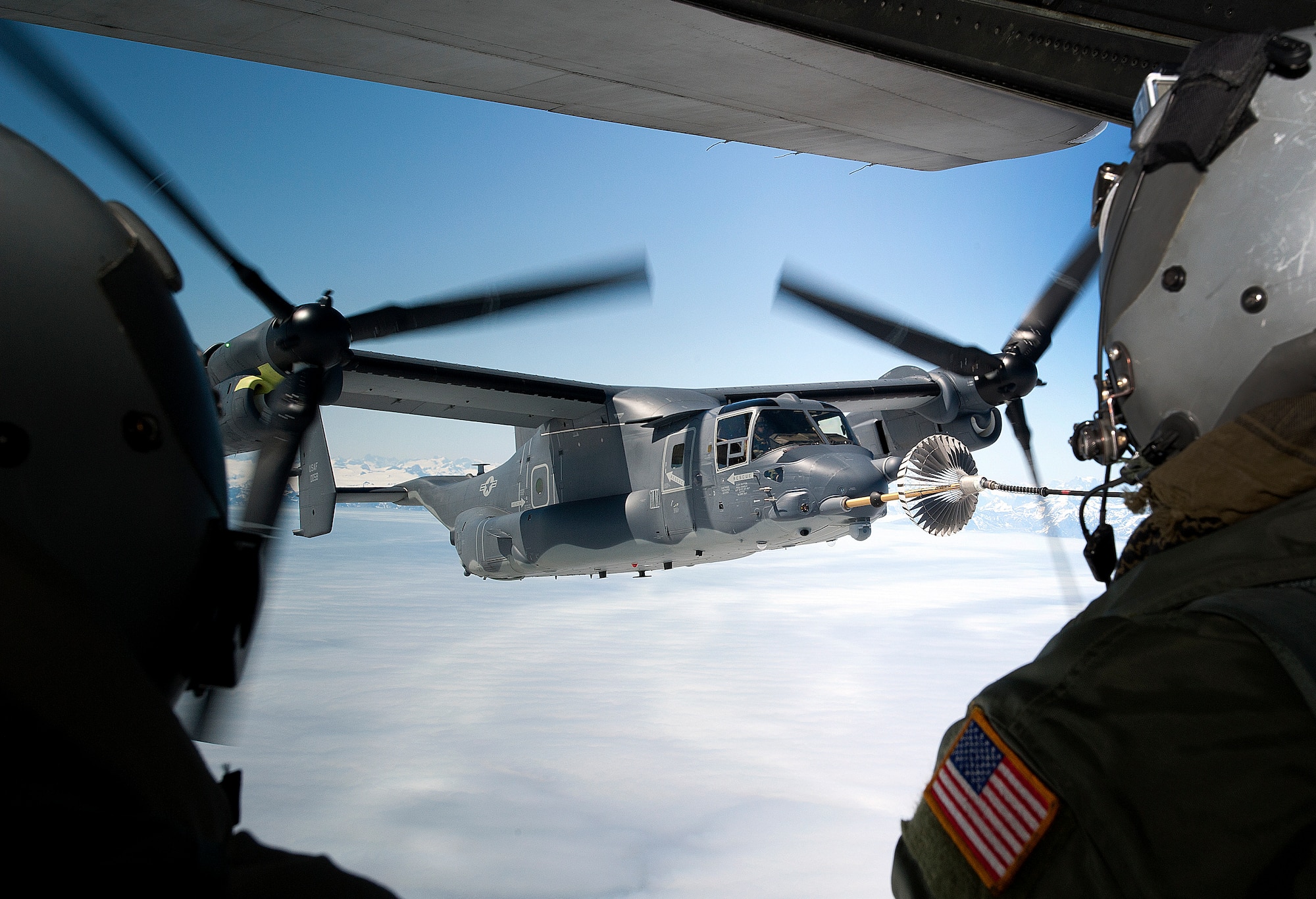 A CV-22B Osprey receives fuel June 21, 2013, off the coast of Greenland by a 7th Special Operations Squadron MC-130H Combat Talon II. The aircraft landed in Iceland during its journey to RAF Mildenhall, England, to allow for crew rest and refueling. The CV-22, assigned to the 7th SOS, is the first of 10 slated to arrive as part of the 352nd Special Operations Group expansion, which will last through the end of 2014. (U.S. Air Force photo by Senior Airman Laura Yahemiak/Released)