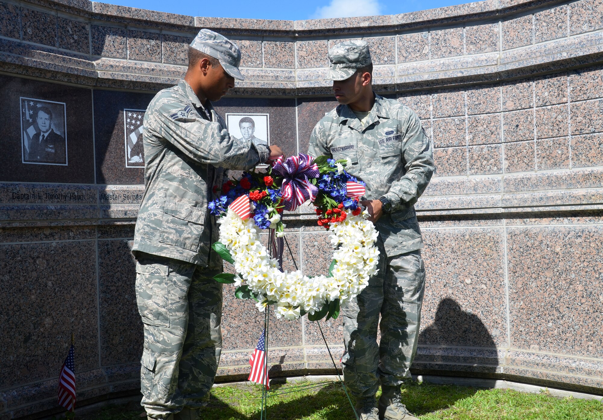 Airman 1st Class Killian Gartner and Gabriel Gonzalez-Marrero, Rescue Reservists from the 308th Rescue Squadron, lay the wreath in front of the Khobar Tower Memorial here. Rescue Wing members honored five Rescue Airmen and 14 other Airmen killed on June 25, 1996. In all, 19 U.S. servicemen and one Saudi were killed and 372 of many nationalities were wounded.  The 920th RQW is an Air Force Reserve combat-search-and-rescue unit comprised of 1,700 Airmen and flies both fixed and rotor wing aircraft. (U.S. Air Force photo/2nd Lt. Leslie Forshaw)