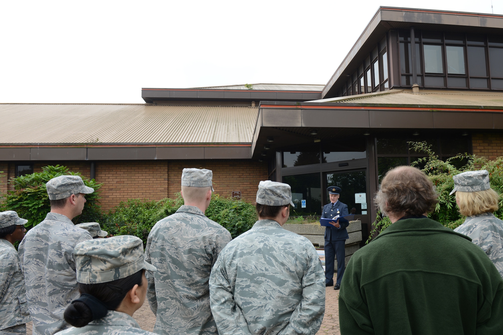 RAF UPWOOD, United Kingdom – RAF Squadron Leader Clive Wood, the RAF Commander for RAF Alconbury, RAF Molesworth and RAF Upwood lead a closure ceremony of the former medical clinic at RAF Upwood, June 19, recognized almost 96 years of an Air Force presence at RAF Upwood. (U.S. Air Force photo by Tech. Sgt. Chrissy Best)