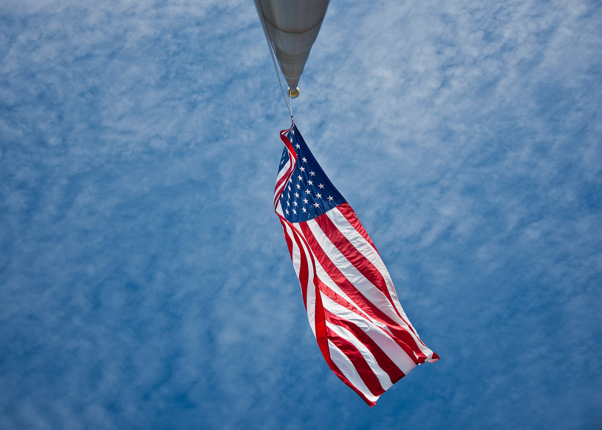 The Eglin Air Force Base flag unfurls in the wind below a blue Florida sky.  Happy Independence Day from Team Eglin.  (U.S. Air Force photo/Samuel King Jr.)
