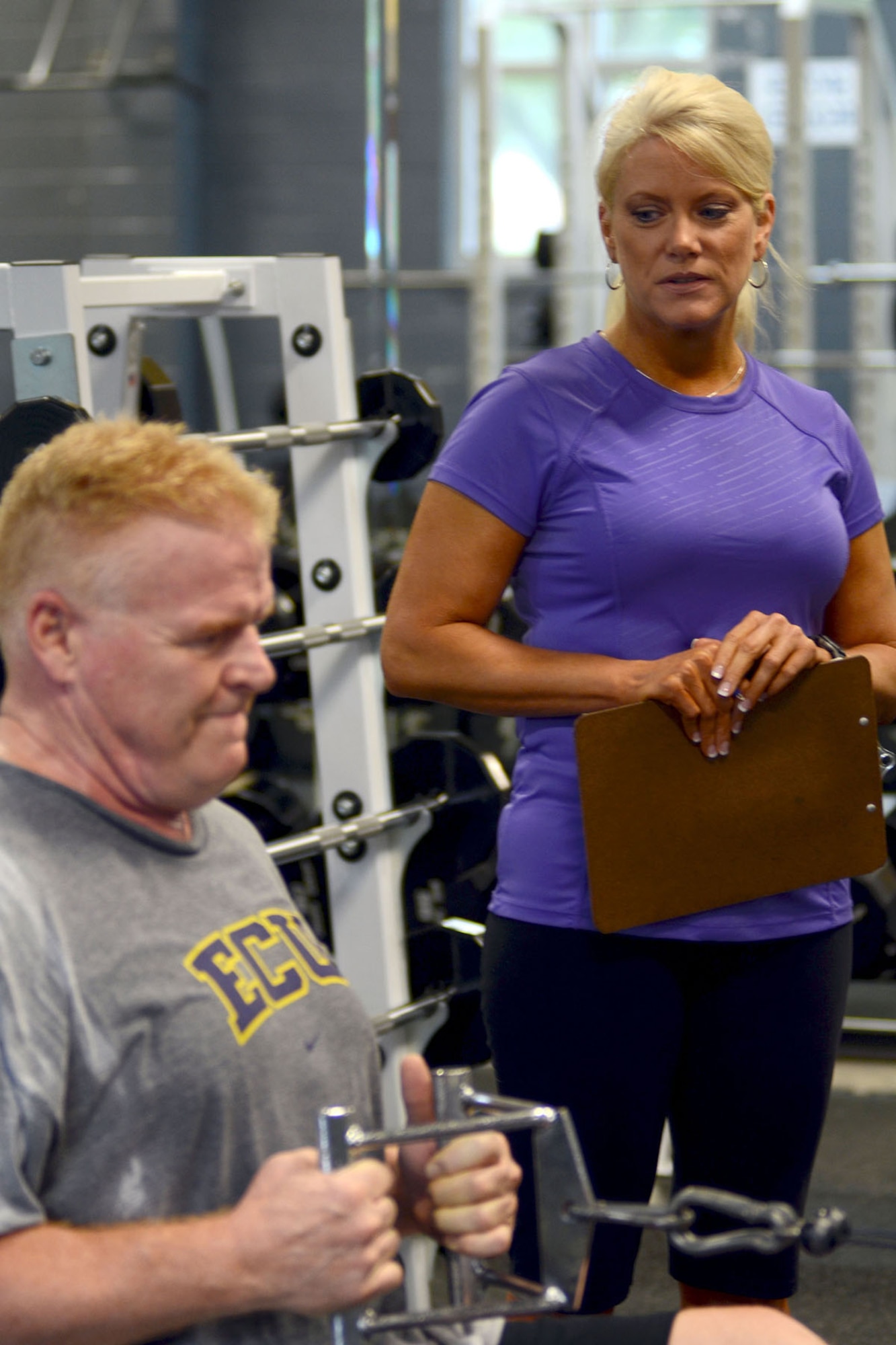 Mrs. Michelle Walker, 169th Force Support Squadron fitness specialist at McEntire Joint National Guard Base, South Carolina Air National Guard, mentors U.S. Air Force Senior Master Sgt. Lee Shepherd, 169th Fighter Wing ground safety manager, during his workout routine in the base gym, June 18, 2013.  (U.S. Air National Guard photo by Tech. Sgt. Caycee Watson/Released)