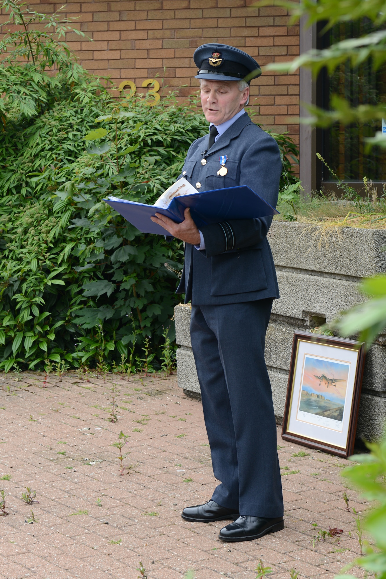RAF UPWOOD, United Kingdom – RAF Squadron Leader Clive Wood, the RAF Commander for RAF Alconbury, RAF Molesworth and RAF Upwood lead a closure ceremony of the former medical clinic at RAF Upwood, June 19, recognized almost 96 years of an Air Force presence at RAF Upwood. (U.S. Air Force photo by Tech. Sgt. Chrissy Best)