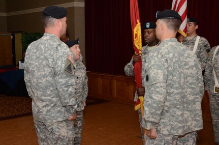 JOINT BASE CHARLESTON - WEAPONS STATION, S.C. — Lt. Col. Brian Memoli, incoming commander, 841st Transportation Battalion, returns the command guidon to Command Sgt. Maj. Marvin Bonner, 841st Transportation Battalion, showing the completion of transfer of command from departing to arriving commander. (U.S. Navy photo/ Petty Officer 1st Class Chad Hallford)
