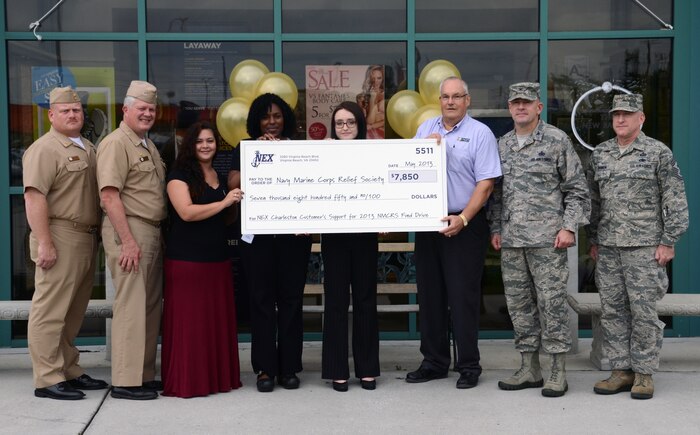 JOINT BASE CHARLESTON - WEAPONS STATION, S.C. — Joint Base Charleston Navy Exchange employees, along with JB Charleston leadership, present the local Navy and Marine Corps Relief Society a check in the amount of $7,850 for funds raised during the Spring 2013 NMCRS fund drive campaign June 20, 2013, at Joint Base Charleston – Weapons Station, S.C. Left to right: Master Chief Petty Officer Joseph Gardner, Naval Support Activity Charleston command master chief, Navy Capt. Thomas Bailey, JB Charleston deputy commander, NEX associates Leanne Elmhorst, Valerie Mabry and Kristina Nagel; David Hastings, Charleston NMCRS director, Col. Richard McComb, JB Charleston commander, and Chief Master Sgt. Earl Hannon, 628th Air Base Wing command chief. (U.S. Navy photo/ Petty Officer 1st Class Chad Hallford)