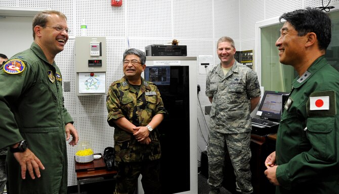 From left: U.S. Air Force Col. Stephen Williams, 35th Fighter Wing commander, Col. Hitohiko Iwasaki, 3rd Air Wing vice commander, Master Sgt. Aaron Mackey, 35th Maintenance Squadron aerospace propulsion maintainer and Maj. Gen. Tamotsu Kidono, 3rd Air Wing commander, interact during a tour of a hush house at Misawa Air Base, Japan, June 25, 2013. Hush houses are soundproof buildings specifically designed to safely contain a running jet engine on a trailer while still being able to observance it and make any adjustments. During William’s meeting with 3 AW leadership, he discussed the upcoming Misawa Air Fest September 15th and the ongoing runway repair. (U.S. Air Force photo by Airman 1st Class Kenna Jackson)