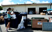 U.S. Air Force Capt. Mayara Coulter, from the 18th Medical Operations Squadron Mental Health flight, separates recyclable items at the recycle center on Kadena Air Base, Japan, June 21, 2013. The recycle center is located at building 871, behind Karing Kennels, near gate 4. (U.S. Air Force photo by Capt. Heather Boytim/Released)