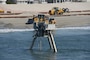 A Coastal Research Amphibious Buggy (CRAB) surveys the surf area of Brant Beach, NJ during beachfill operations in June 2013. 