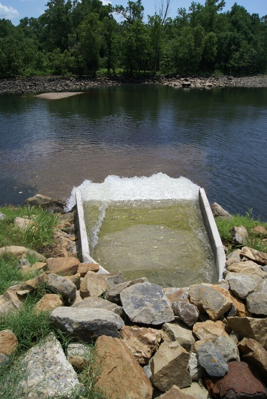 Water gushes from the low flow pipe system into the stream below the Tenkiller Dam. The low flow pipe system transports water from the surge tank at the hydropower plant to the stream.