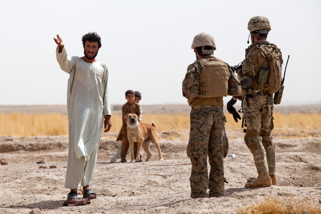 Georgian soldiers speak with an Afghan villager during Operation Northern Lion in Mohammad Abad village in Helmand province, Afghanistan, June 24, 2013.
