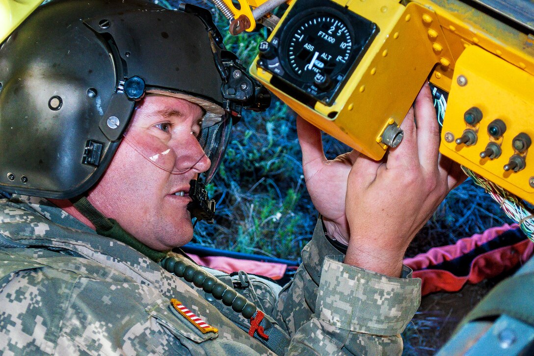 Army Sgt. Nicholas Parrott prepares a Bambi bucket for a CH-47 Chinook helicopter to help fight the East Peak fire near La Veta, Colo., June 21, 2013. Parrott is assigned to the Colorado Army National Guard's 2nd Battalion, 135th Aviation Regiment, stationed on Buckley Air Force Base in Aurora, Colo. 