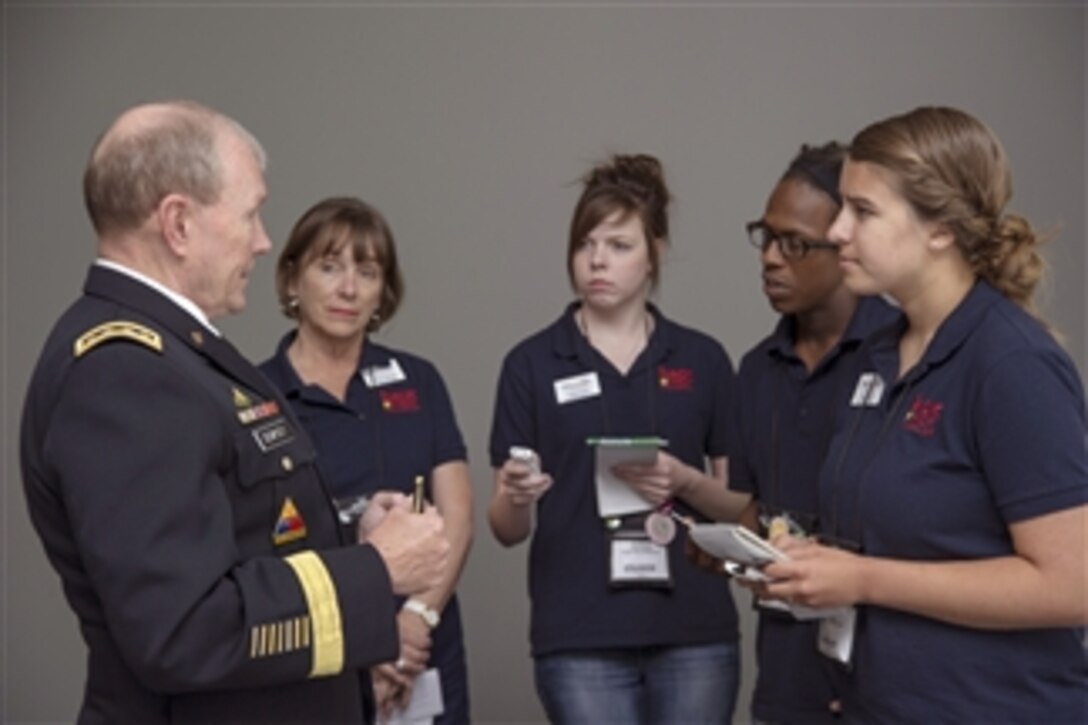 Chairman of the Joint Chiefs of Staff Gen. Martin E. Dempsey speaks with Back Pack Journalists at the Points of Light Conference on Volunteering and Service Military Summit in Washington, D.C., on June 21, 2013.  