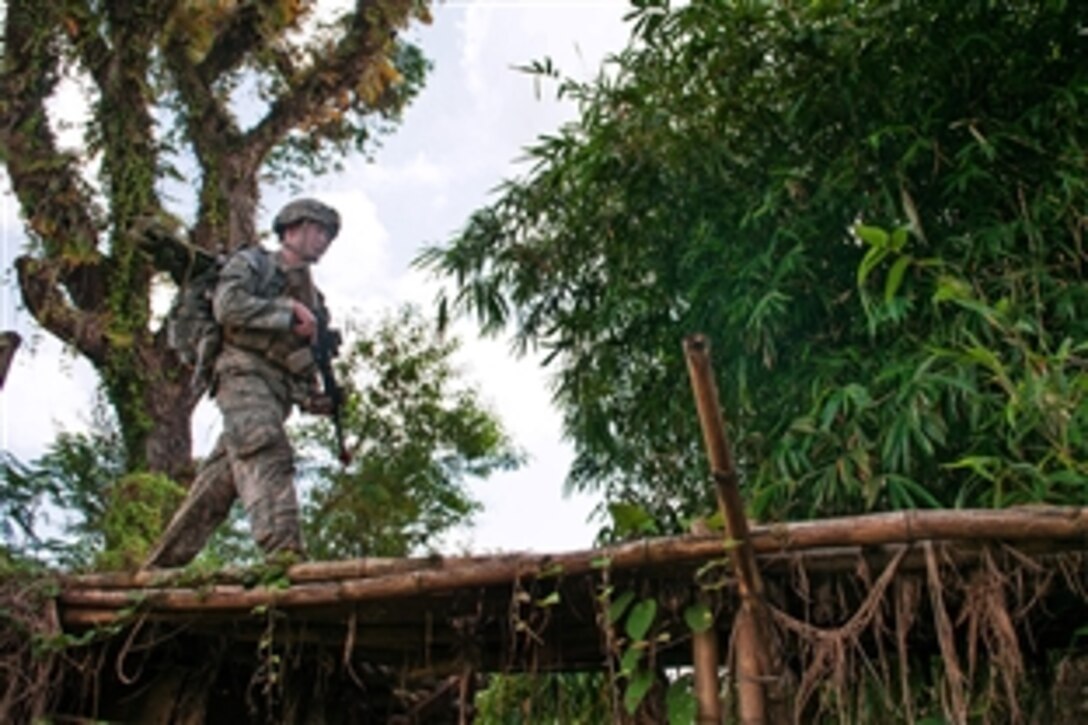 U.S. Army 1st Lt. Shane Joyce leads a patrol across a bridge during a field training exercise with Indonesian army paratroopers as part of exercise Garuda Shield 2013 bilateral training in West Java, Indonesia, June 18, 2013. Joyce, a platoon leader, is assigned to the 82nd Airborne Division’s 1st Brigade Combat Team.