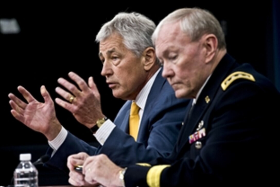 Defense Secretary Chuck Hagel, left, and Army Gen. Martin E. Dempsey, chairman of the Joint Chiefs of Staff, brief reporters at the Pentagon, June 26, 2013. Hagel announced that President Barack Obama has nominated both Dempsey and Navy Adm. James A. Winnefeld Jr., vice chairman of the Joint Chiefs of Staff, to second terms. 
