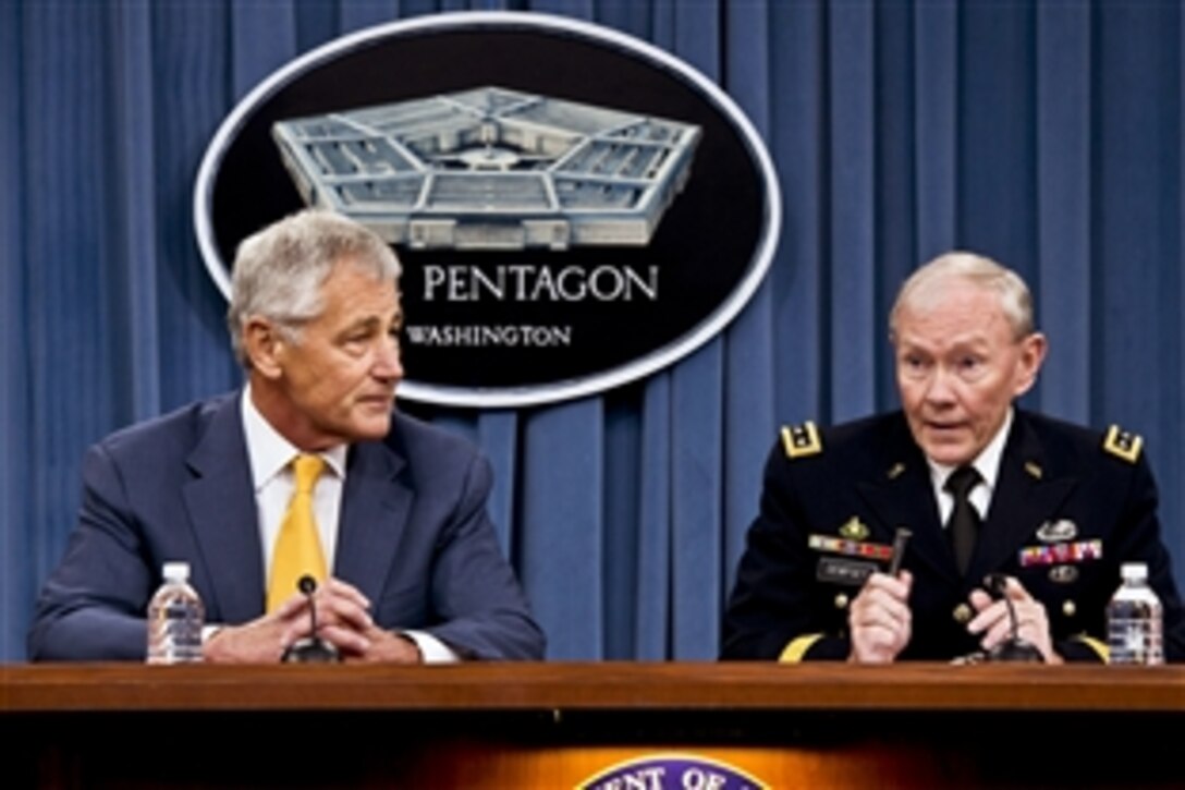 Defense Secretary Chuck Hagel, left, and Army Gen. Martin E. Dempsey, chairman of the Joint Chiefs of Staff, brief reporters at the Pentagon, June 26, 2013. Hagel announced that President Barack Obama has nominated both Dempsey and Navy Adm. James A. Winnefeld Jr., vice chairman of the Joint Chiefs of Staff, to a second term.  
