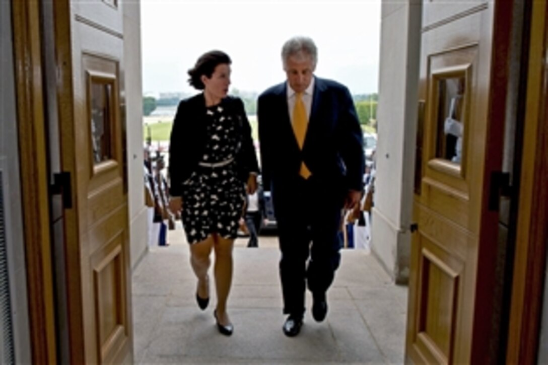 U.S. Defense Secretary Chuck Hagel escorts Swedish Defense Minister Karin Enstrom following an honor cordon at the Pentagon, June 26, 2013. Both leaders met to discuss issues of mutual concern. 