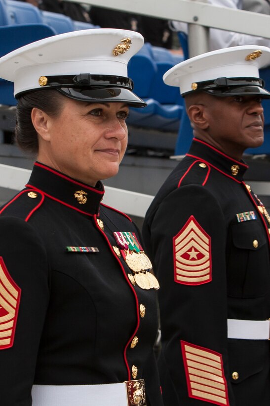 Sgt. Maj. Eric J. Stockton, former Marine Barracks Washington, D.C. sergeant major, right, and Sgt. Maj. Angela M. Maness, the Barracks sergeant major, left, stand side-by-side during a relief and appointment ceremony at the Barracks June 27. Maness assumed her post after relieving Stockton. Stockton retired during the ceremony after more than 30 years of service.