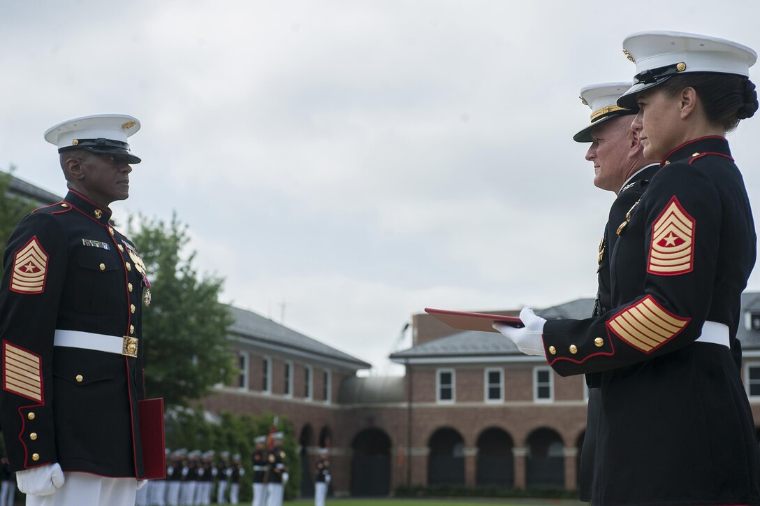 Sgt. Maj. Eric J. Stockton, former Marine Barracks Washington, D.C. sergeant major, stands at the position of attention while the order for his award is read during a relief and appointment ceremony at the Barracks June 27. During the ceremony, Stockton relinquished his post to Sgt. Maj. Angela M. Maness and retired after more than 30 years of service.