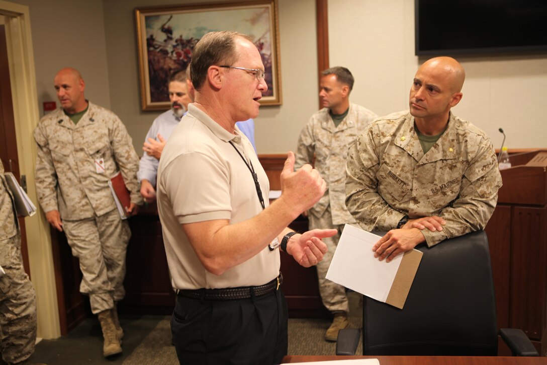 James Carothers, representative from Marine Forces North, and Maj. Jason Burkett, Headquarters Marine Corps’ Manpower and Reserve Affairs representative, discuss operational logistics after the conclusion of the first Marine Corps lead Defense Support of Civil Authorities working group at the Marine Force Reserve and MARFORNORTH headquarters, June 20. Representatives from major U.S. Marine Corps headquarters based in the U.S., gathered in support of DSCA to discuss and synchronize natural disaster response efforts and capabilities, review current operational requirements and prepare for the upcoming hurricane and wildland fire season.(Official U.S. Marine Corps photo by Cpl. Fenton Reese)
